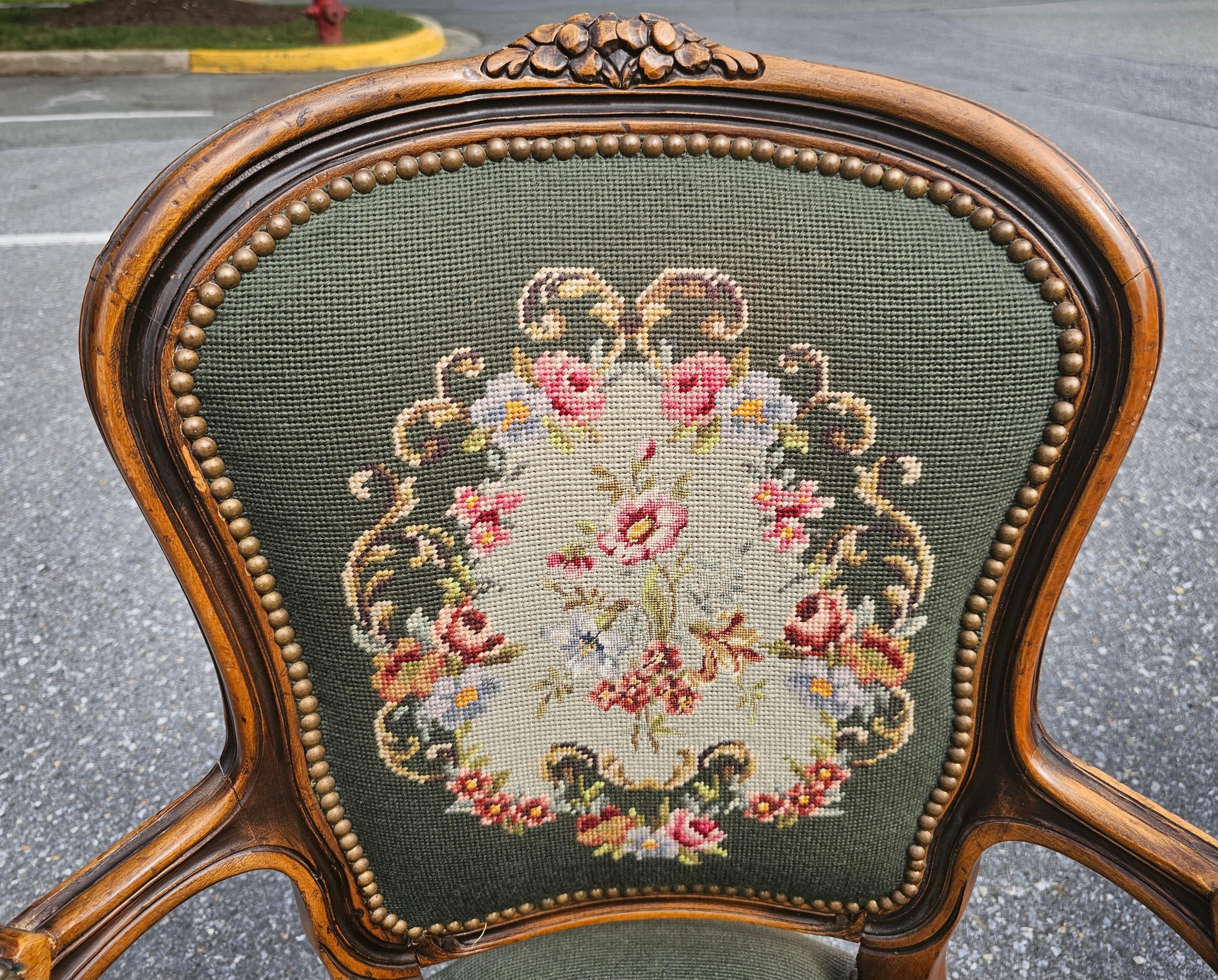 Beautiful Pair of French Louis XVI Carved Fruitwood and Needlepoint Upholstered Bergeres. Very good vintage condition with firm seats. Dark green with minor fading. Listing price for the pair