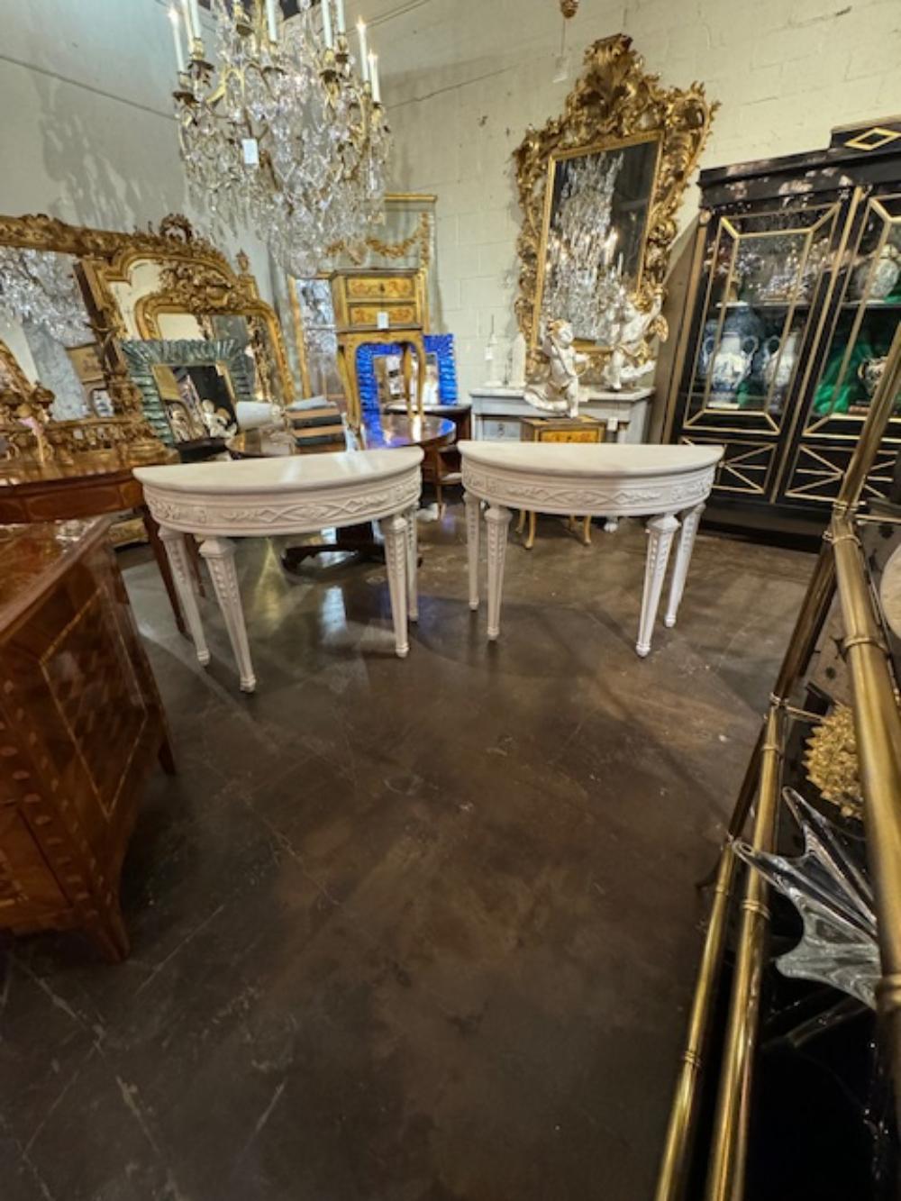 Gorgeous pair of French Louis XVI style carved and painted Neo-Classical demi-lune consoles. Very fine quality. Creates a beautiful classic look! Circa 1940.
42w x 19d x 32h