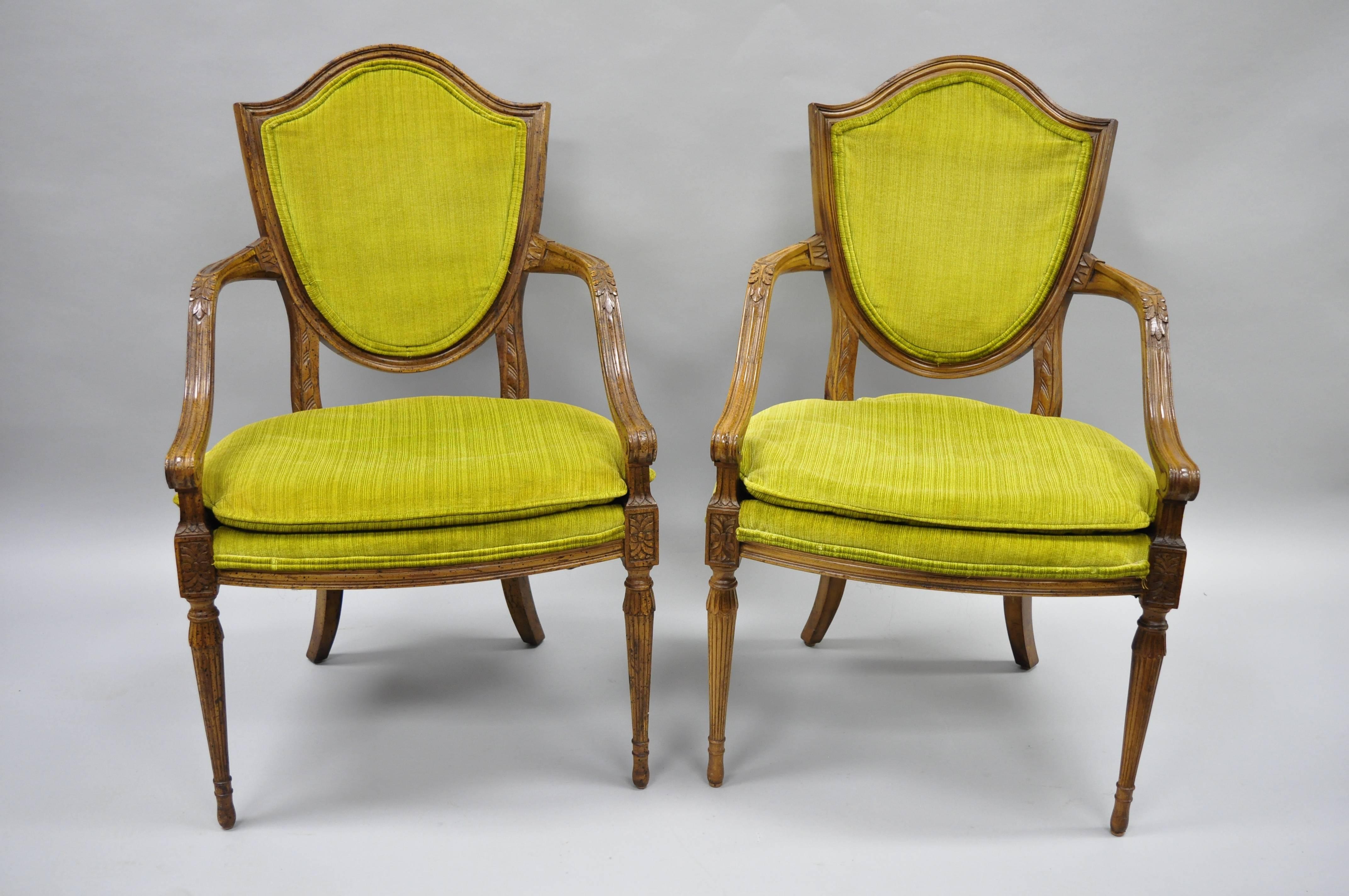 Pair of vintage French Louis XVI / Directoire style armchairs with shield back by American of Martinsville. Item features shapely arms with feather carvings, shield backs, solid wood frame, nicely carved details, tapered legs, quality American