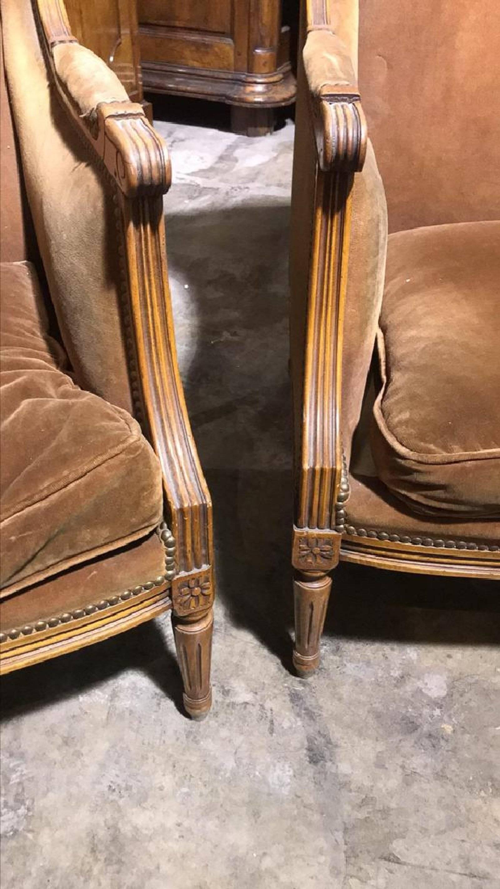 Handsome pair of circa 1940s French Louis XVI style carved fruitwood wingback upholstered bergeres. Superb lines! Classic design!

 