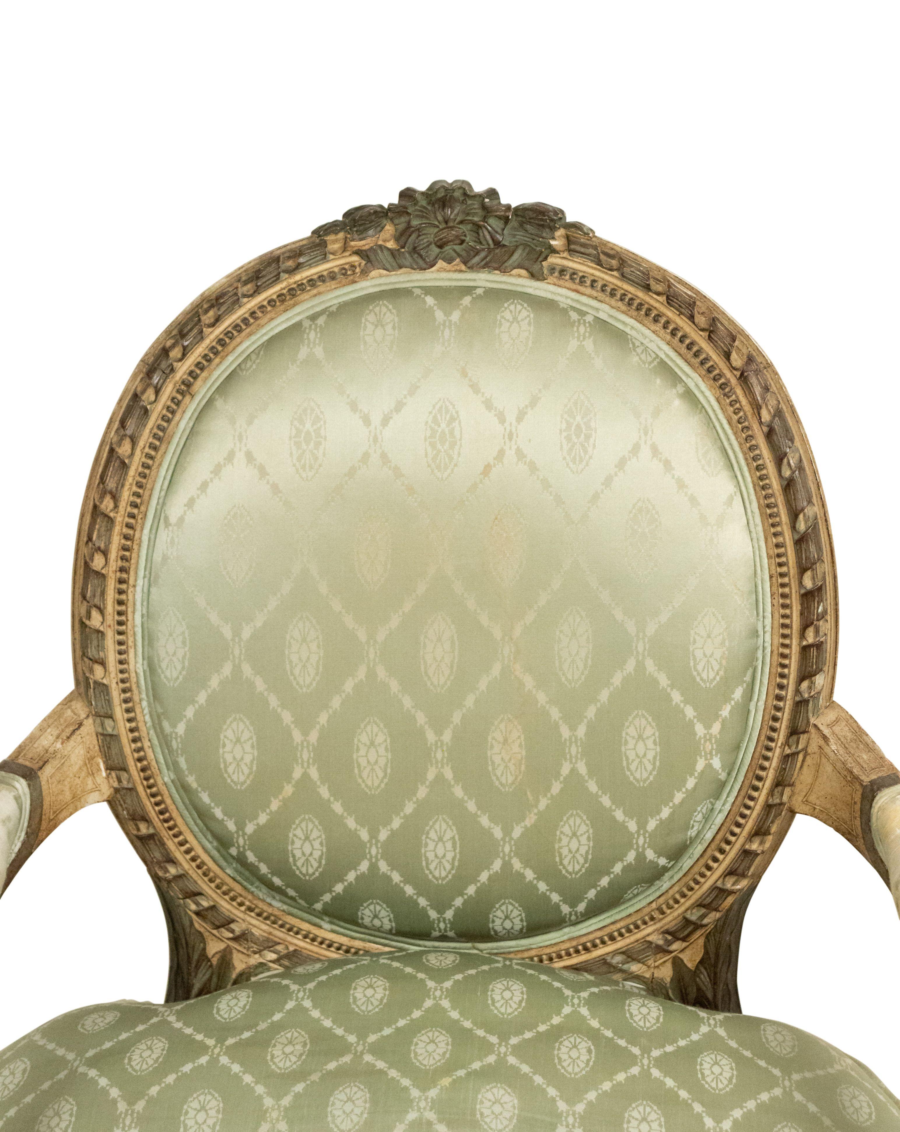 Pair of French Louis XVI-style (19th/20th Cent) grey painted armchairs with oval back in pale green silk upholstery.
   