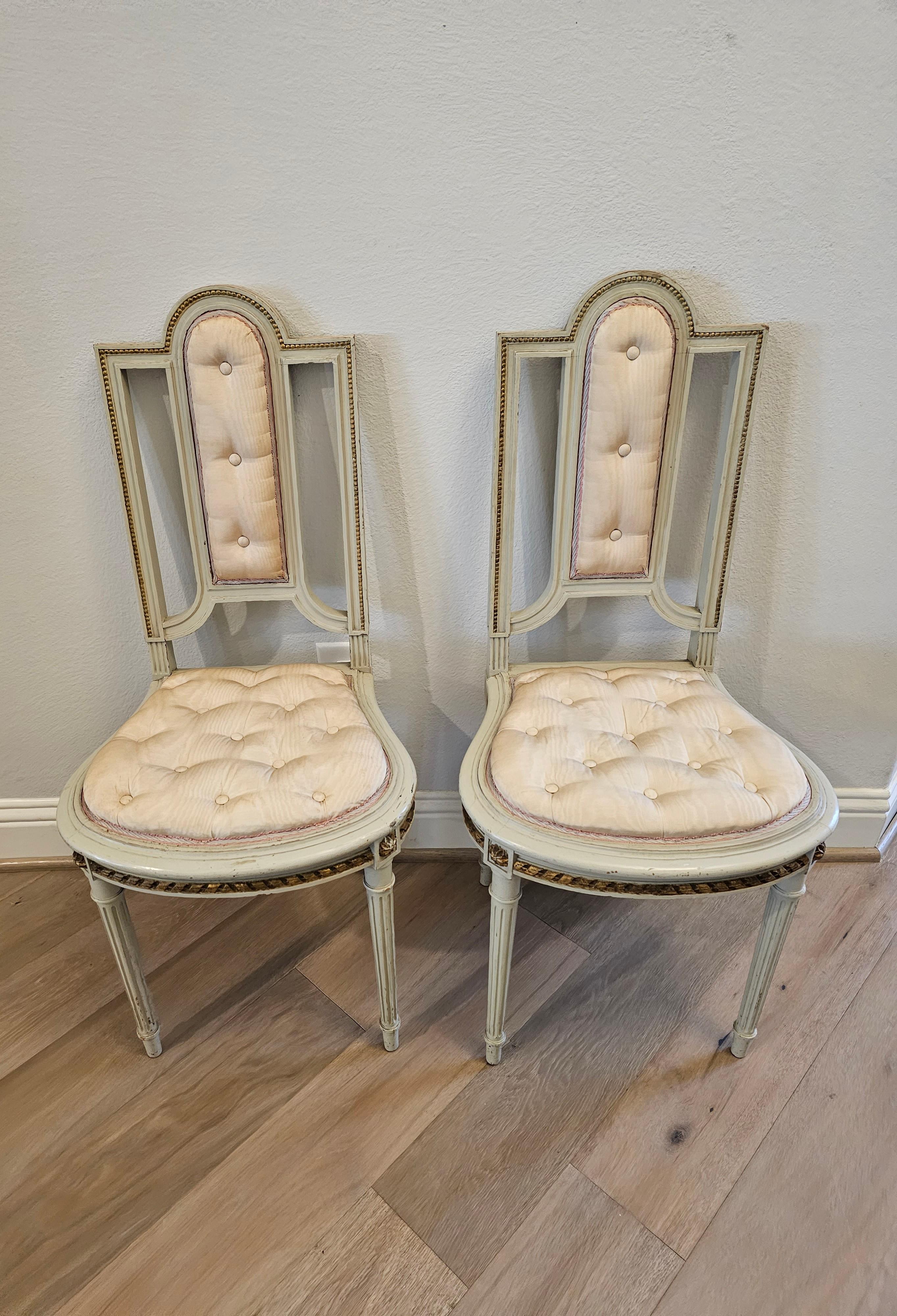 Hand-Carved Pair of French Louis XVI Painted Parcel Gilt Petite Antique Chairs For Sale