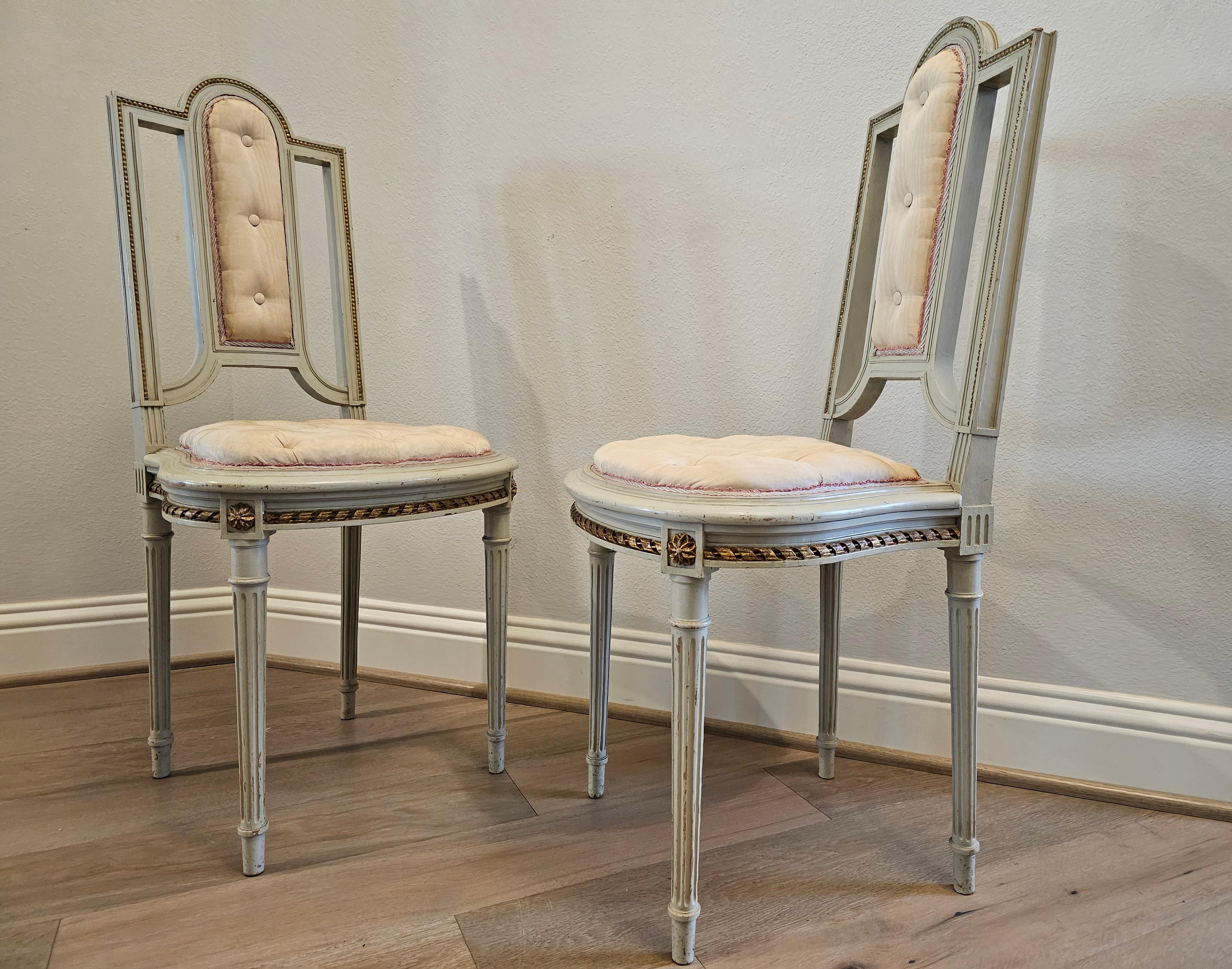 20th Century Pair of French Louis XVI Painted Parcel Gilt Petite Antique Chairs For Sale