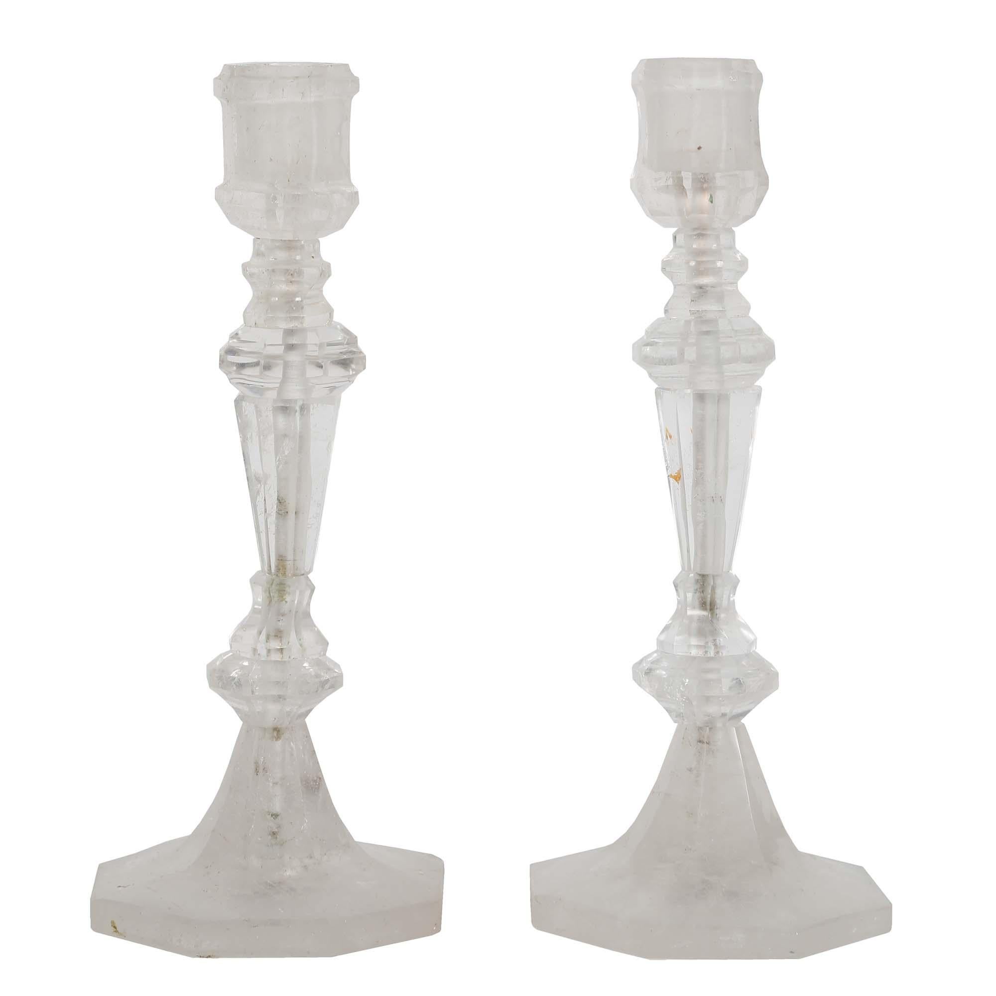 A wonderful pair of French Louis XVI style rock crystal candlesticks. Each unique rock crystal candlestick is raised by an octagonal base tapering up to the finely cut central fut and candle cup.