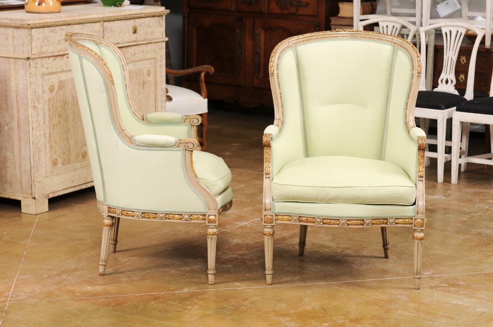 Upholstery Pair of French Louis XVI Style 1900s Painted and Parcel-Gilt Bergères Chairs For Sale