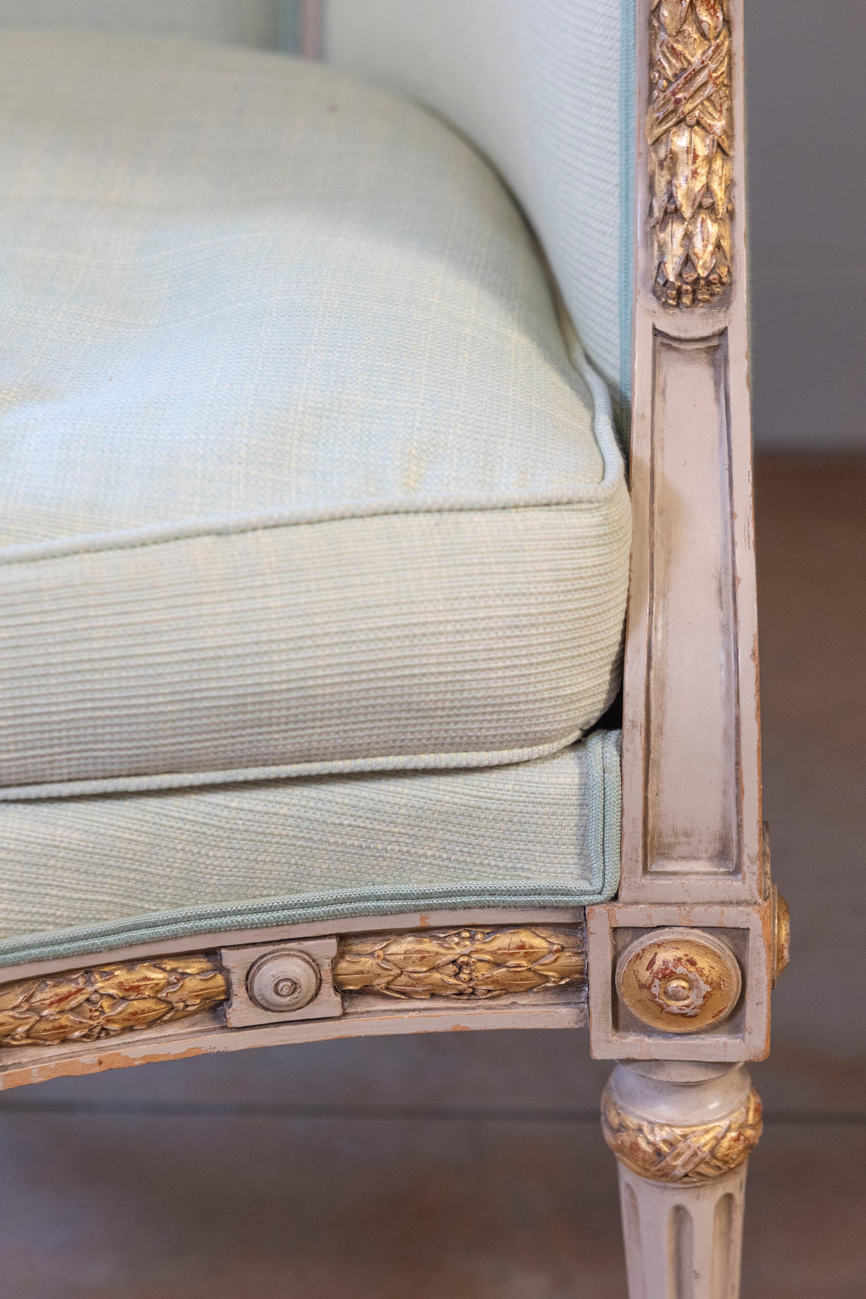 Upholstery Pair of French Louis XVI Style 1900s Painted and Parcel-Gilt Bergères Chairs For Sale