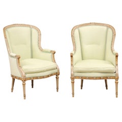 Pair of French Louis XVI Style 1900s Painted and Parcel-Gilt Bergères Chairs