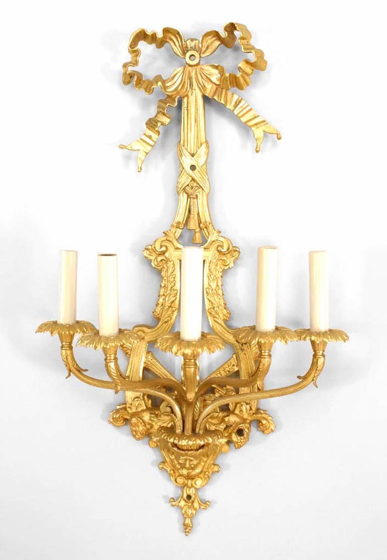 Pair of French Louis XVI-style (19th Century) bronze dore wall sconces with five arms, bow knot design, lyre-shaped center pieces and masks at bottoms (PRICED AS Pair)

