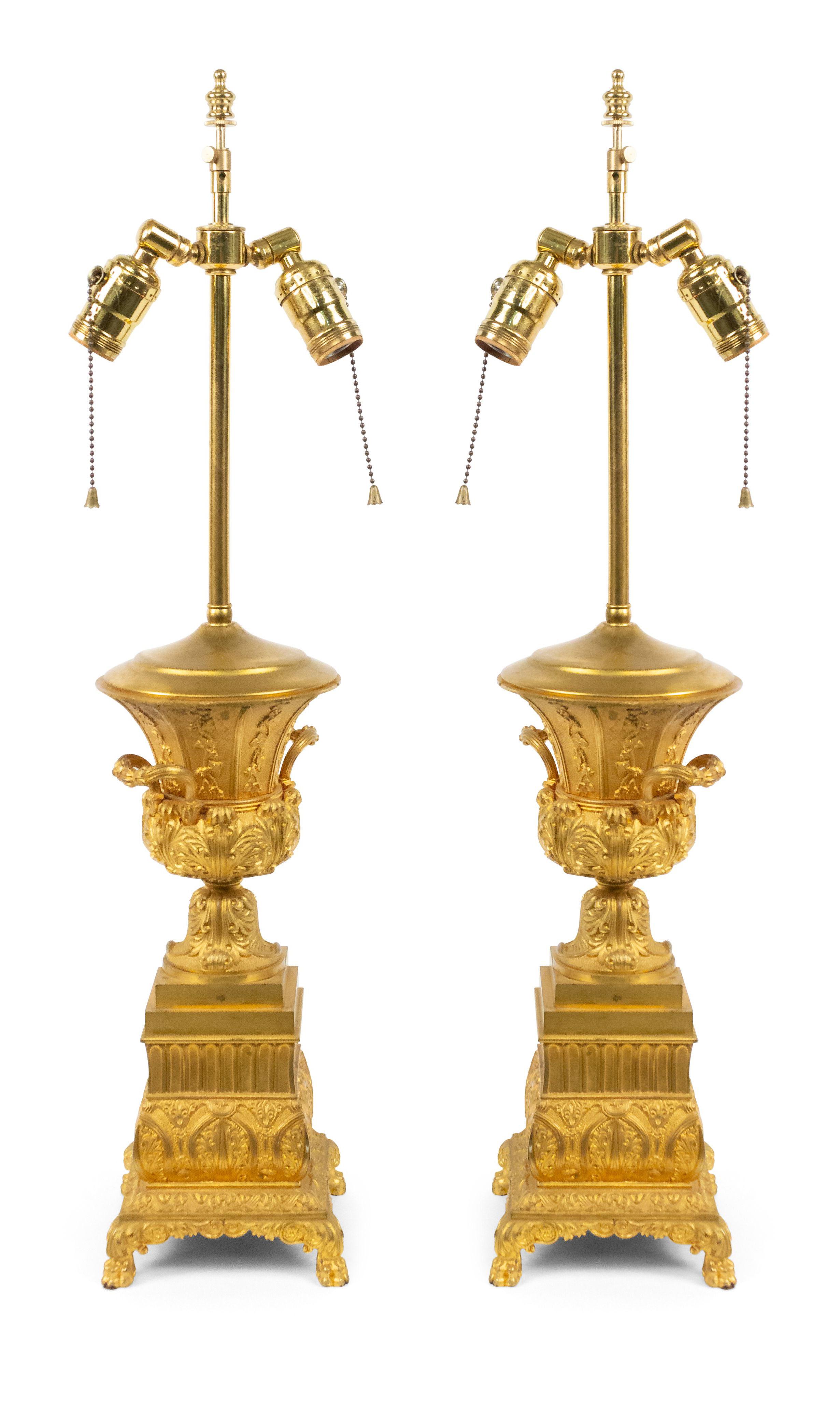 Pair of French Charles X (19th Century) bronze dore urns mounted as table lamps with side handles (PRICED AS Pair).
