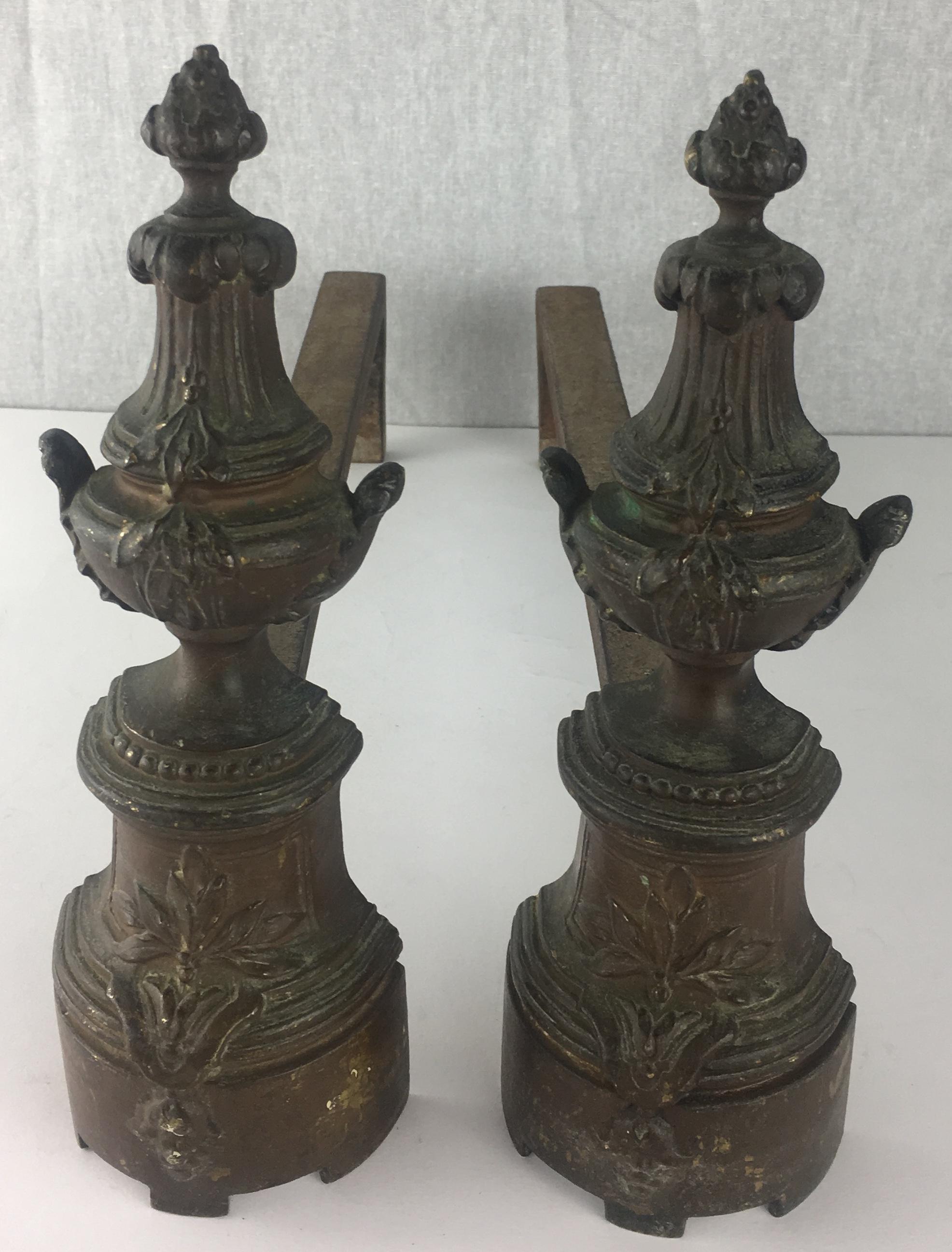 Pair of 19th Century French Louis XVI style brass chenets or andirons.

Very good antique condition. Unpolished bronze. 
Minor rust on the bottom. 
 