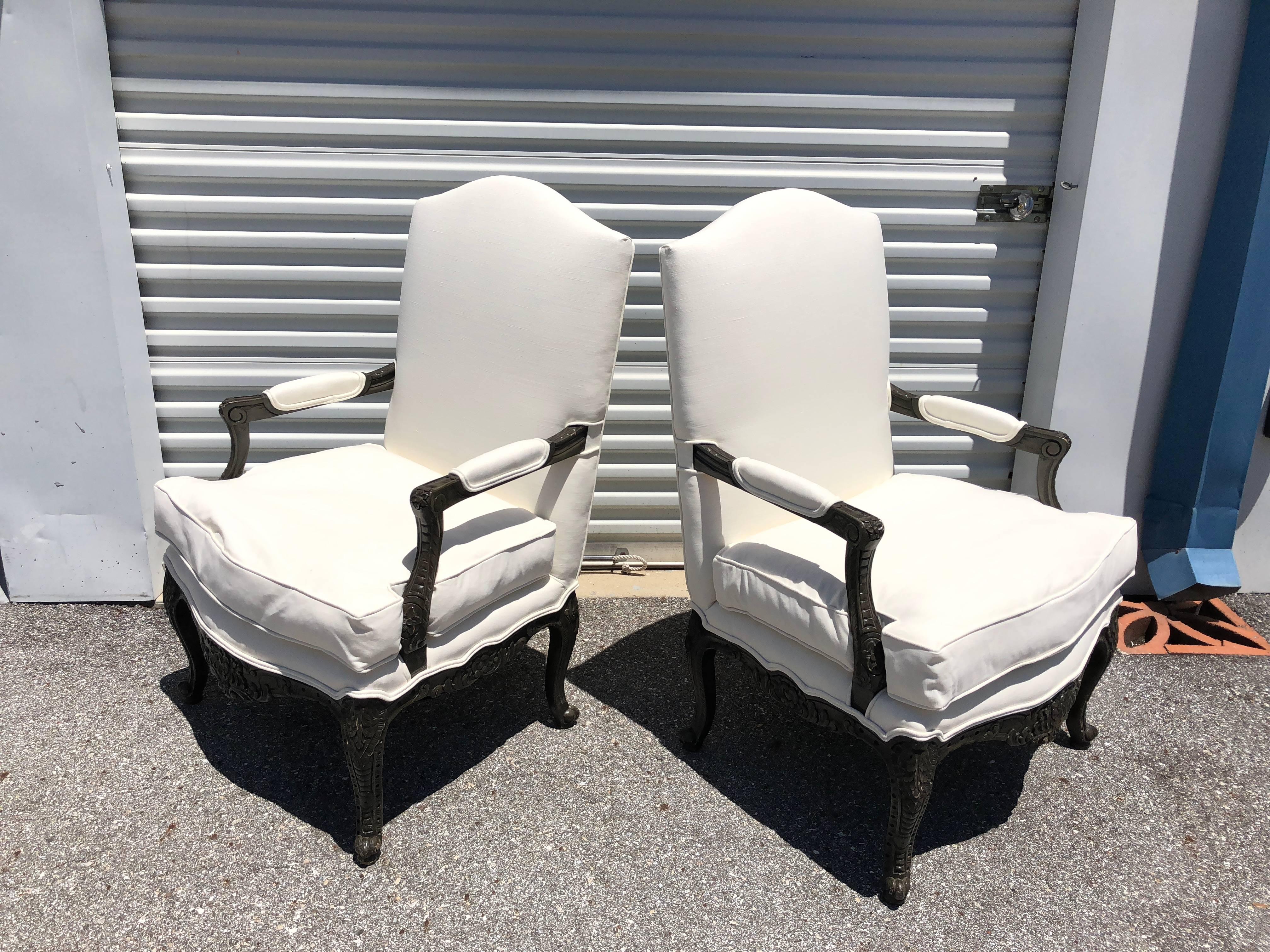 This pair of French style armchairs have carved legs, front and side panels finished in black lacquer. They have been newly upholstered having a separate cushion filled with down and rapped cushion inside (very comfortable)
circa 1970s.