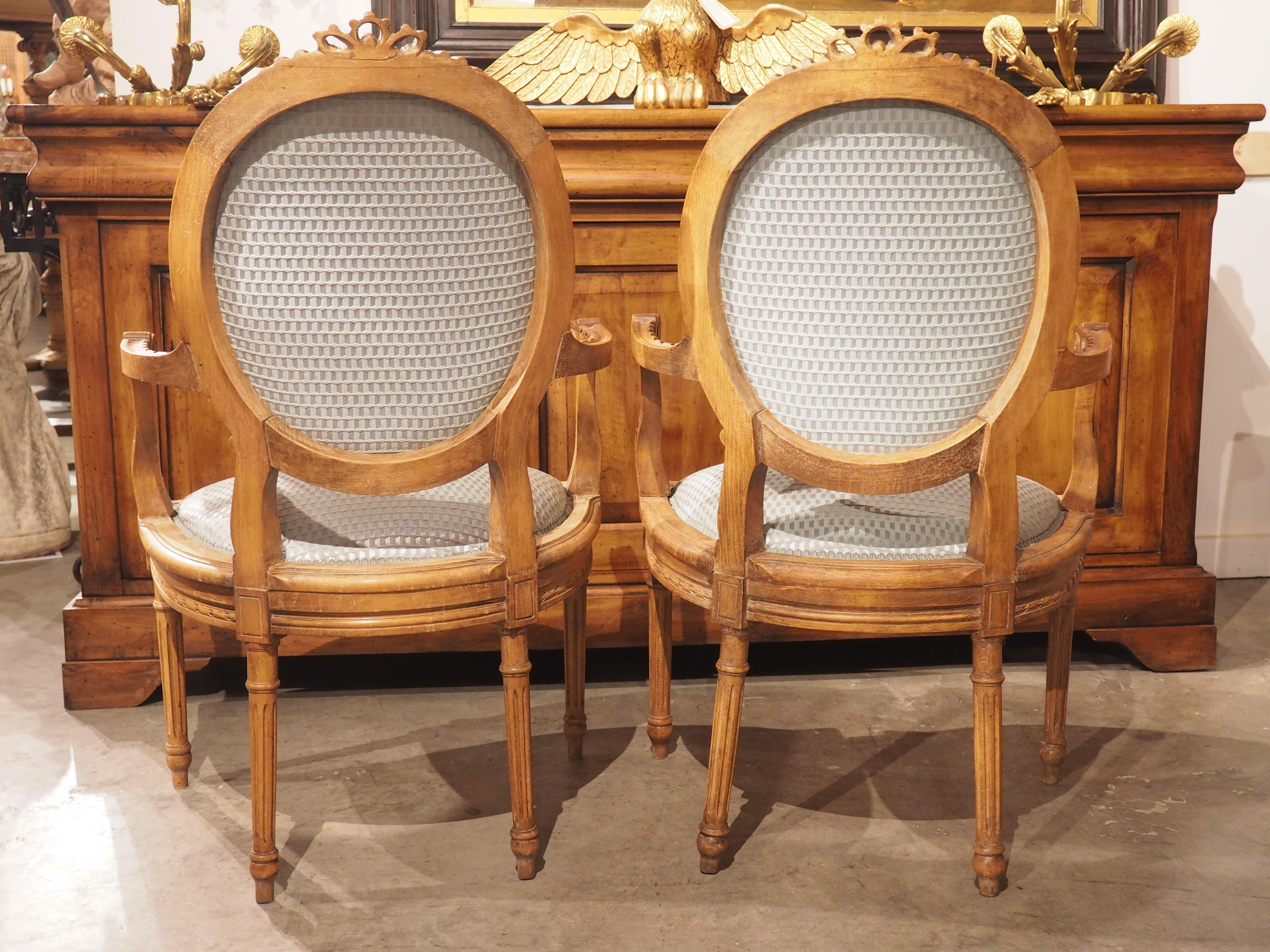 Pair of French Louis XVI Style Beechwood and Blue Silk Cabriolet Armchairs For Sale 11