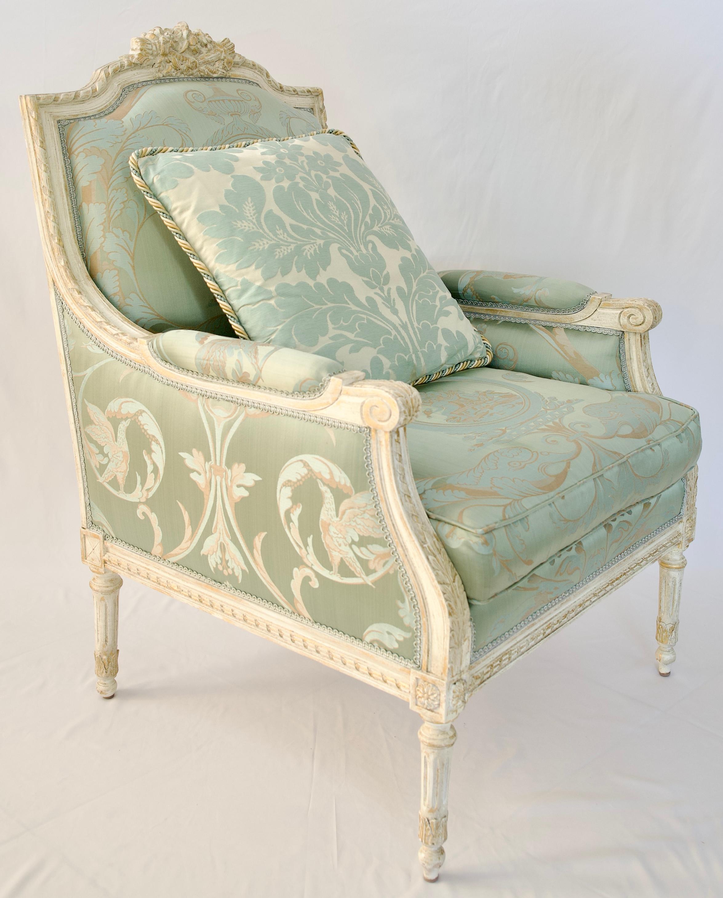 A fine quality pair of Louis XVI style Bergère armchairs hand-painted with great attention to details. The Lelievre silk fabric and color of the upholstery makes these armchairs particularly pleasing to the eye and wonderful choices. Custom pillows