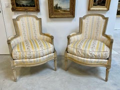 Pair of French Louis XVI Style Bergères Chairs with Fluted Legs and Rosettes