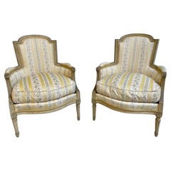 Pair of French Louis XVI Style Bergères Chairs with Fluted Legs and Rosettes