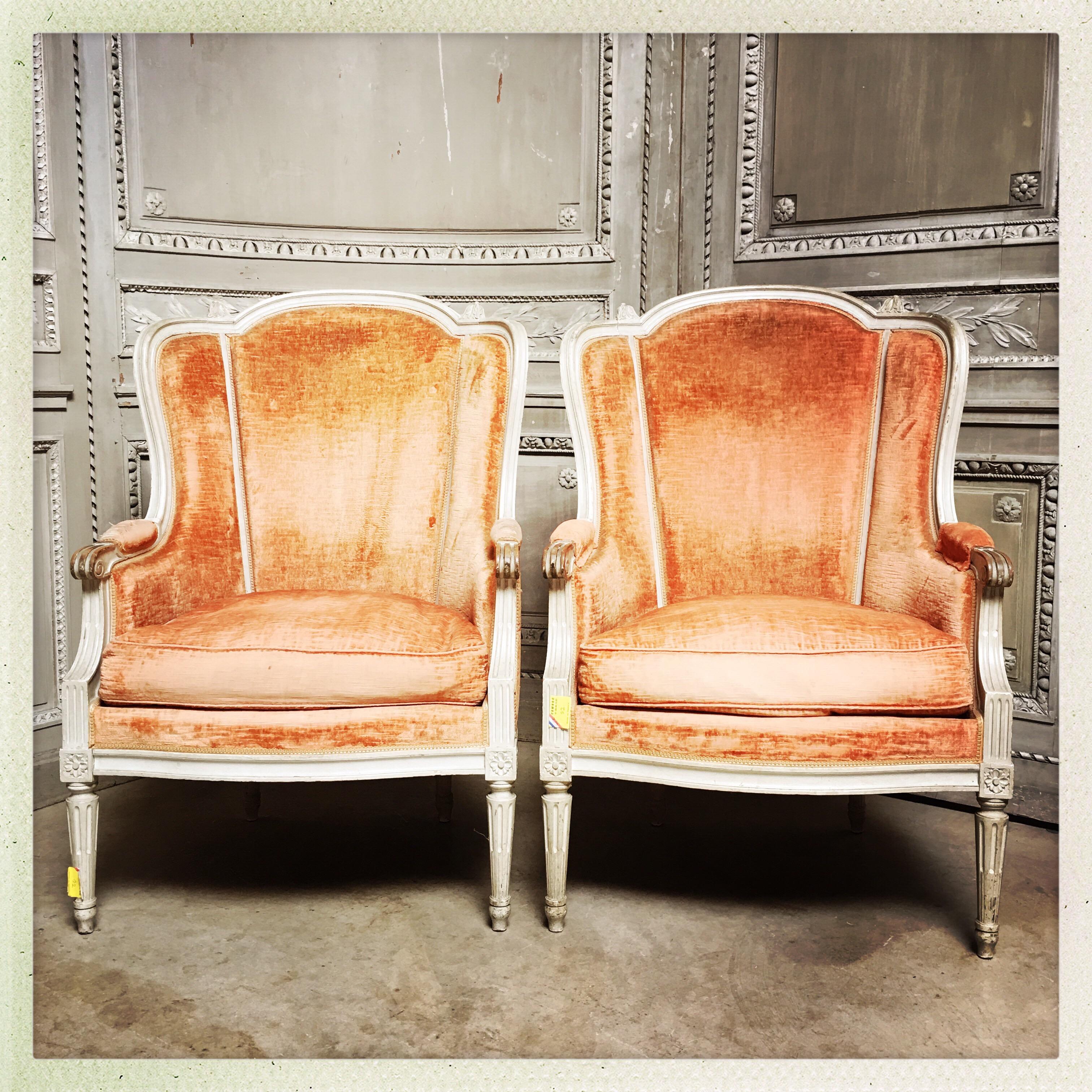 A pair of large French Louis XVI style bergeres with a painted gray finish.