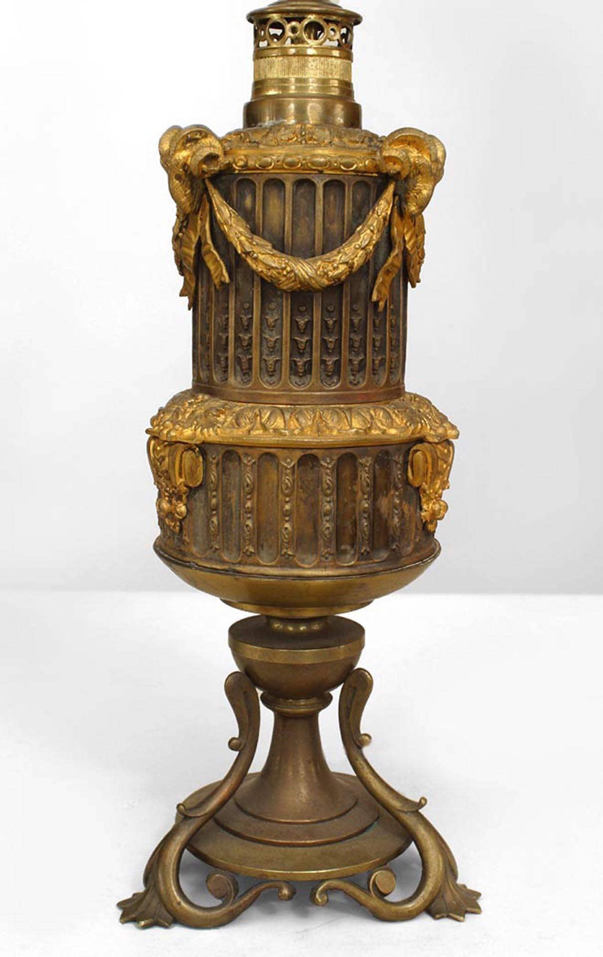 Paar französische Tischlampen im Louis-XVI-Stil (19. Jh.) aus Bronze und mit vergoldeten Verzierungen, mit Widderköpfen und Girlanden (PREIS FÜR Pärchen).

