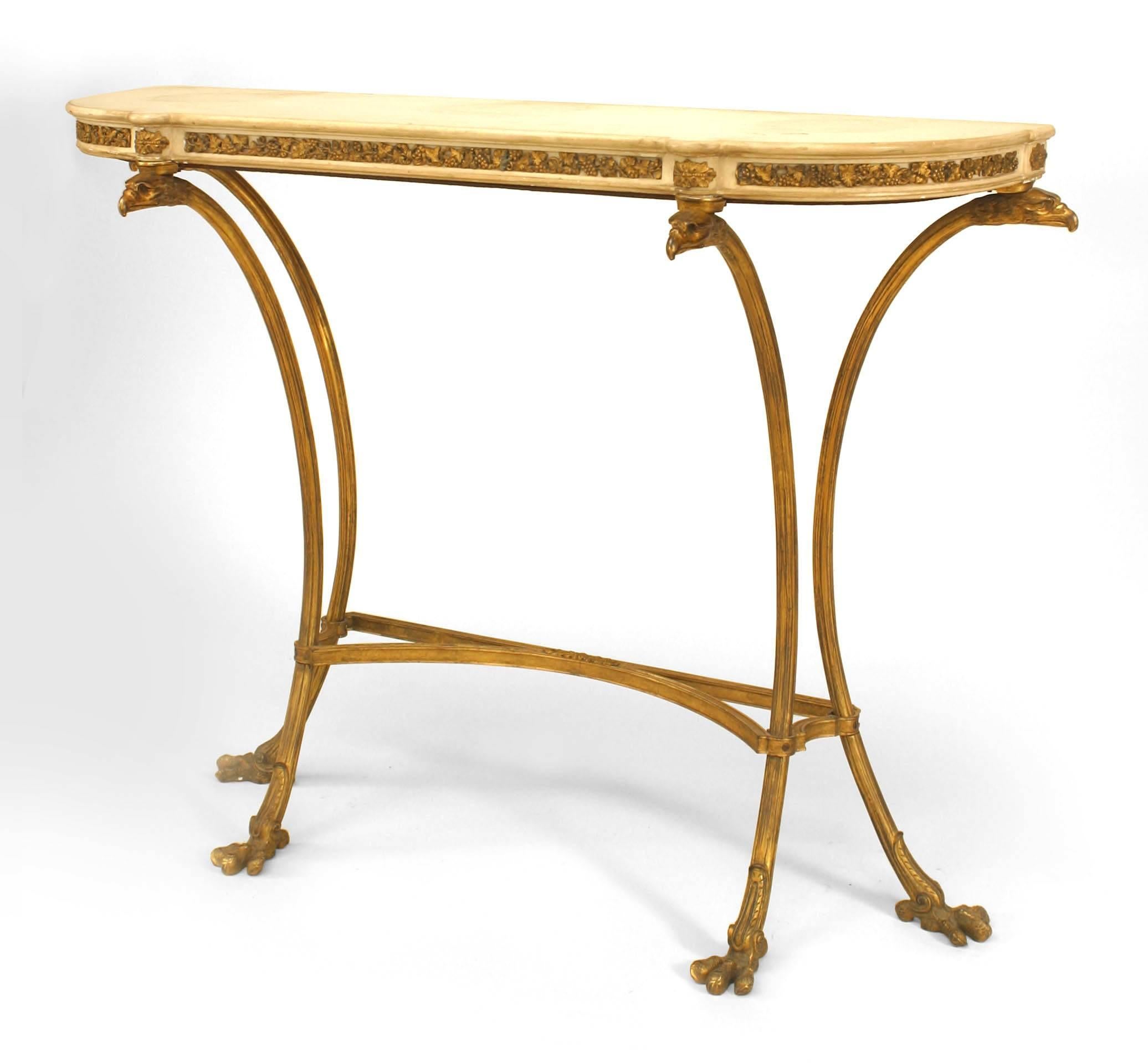 Pair of French Louis XVI-style bronze dore console tables with eagle head design and white marble top. (PRICED AS Pair)
