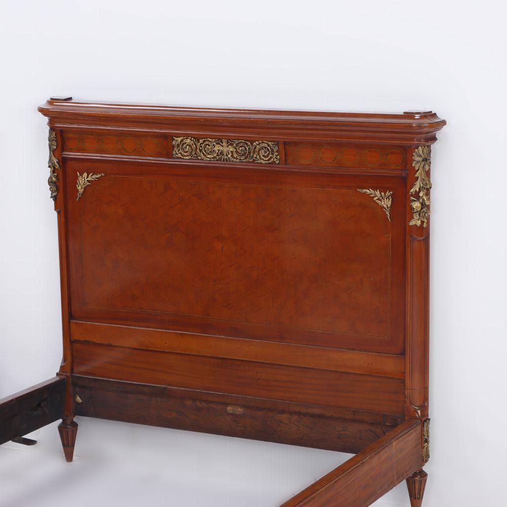 Pair of French Louis XVI style bronzePair of French Louis XVI style bronze mounted twin beds C 1920. The headboards and footboards having elaborate marquetry inlay of flowers, geometric shapes and bows, as well as bronze mounts. Note there is a