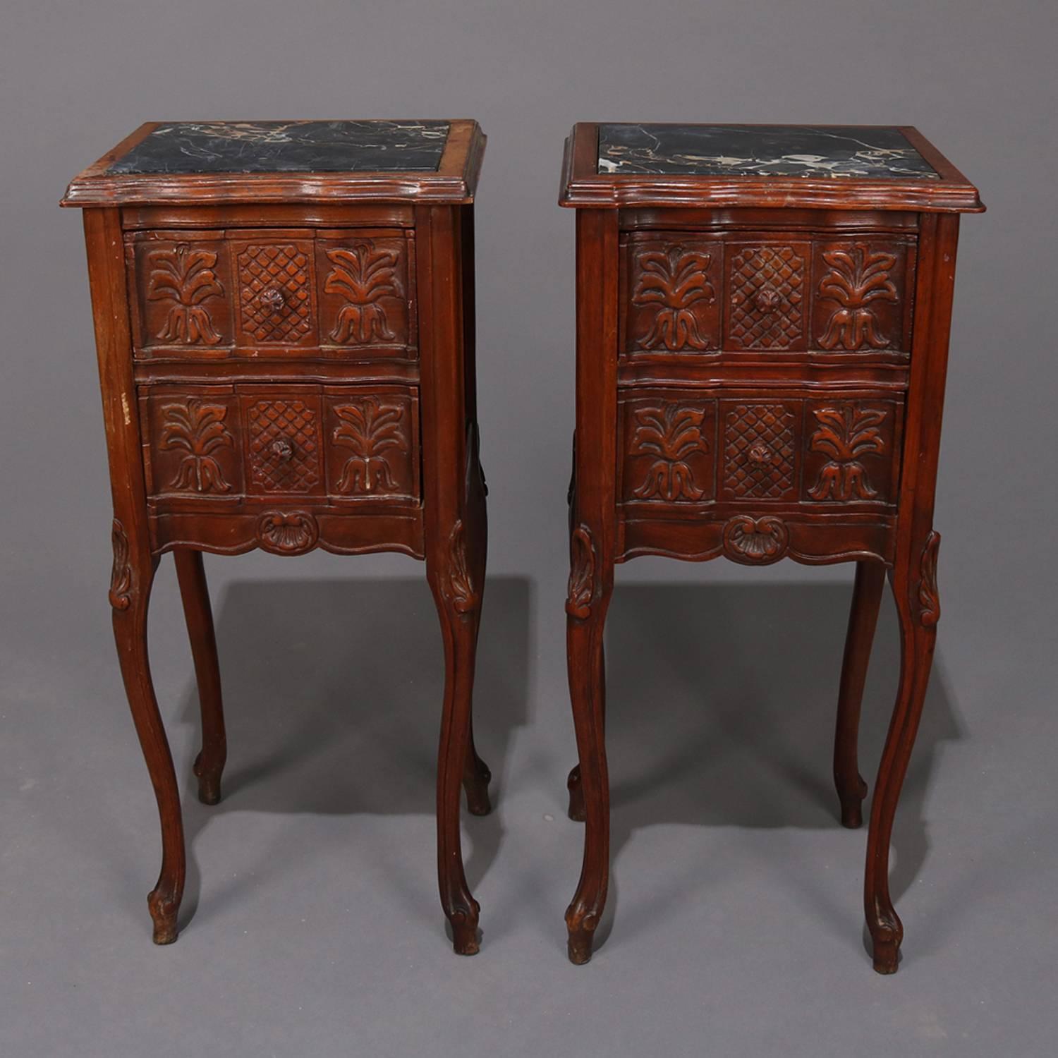 Pair of French Louis XVI style carved mahogany end stands feature shaped top with inset marble, two drawer case having carved foliate and palm decoration and raised on cabriole legs with carved acanthus knees, 20th century

Measures: 29.25
