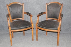 Pair of French Louis XVI Style Carved Walnut Armchairs With Black Upholstery