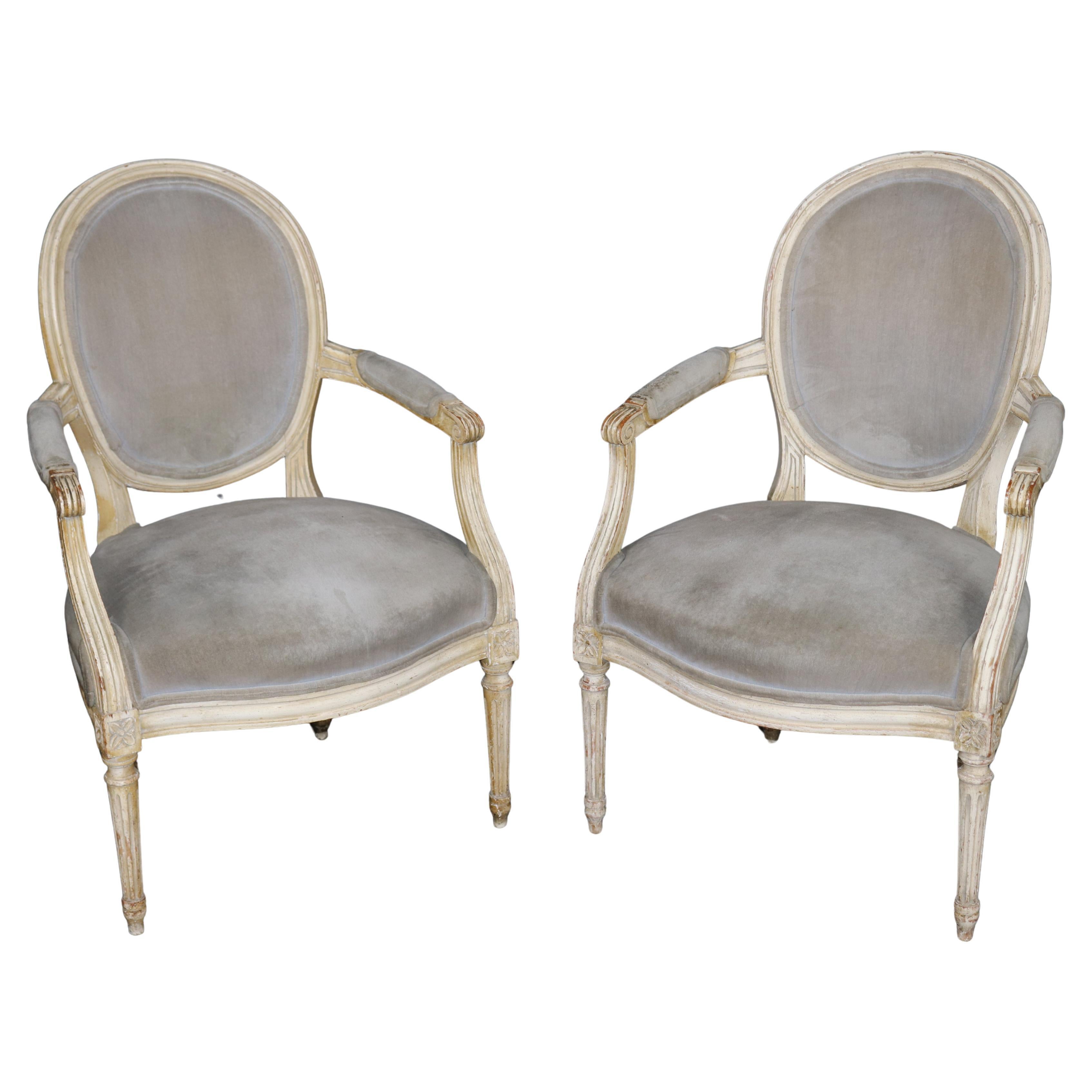 Pair of French Louis XVI Style Distressed White Paint Decorated Arm Chairs