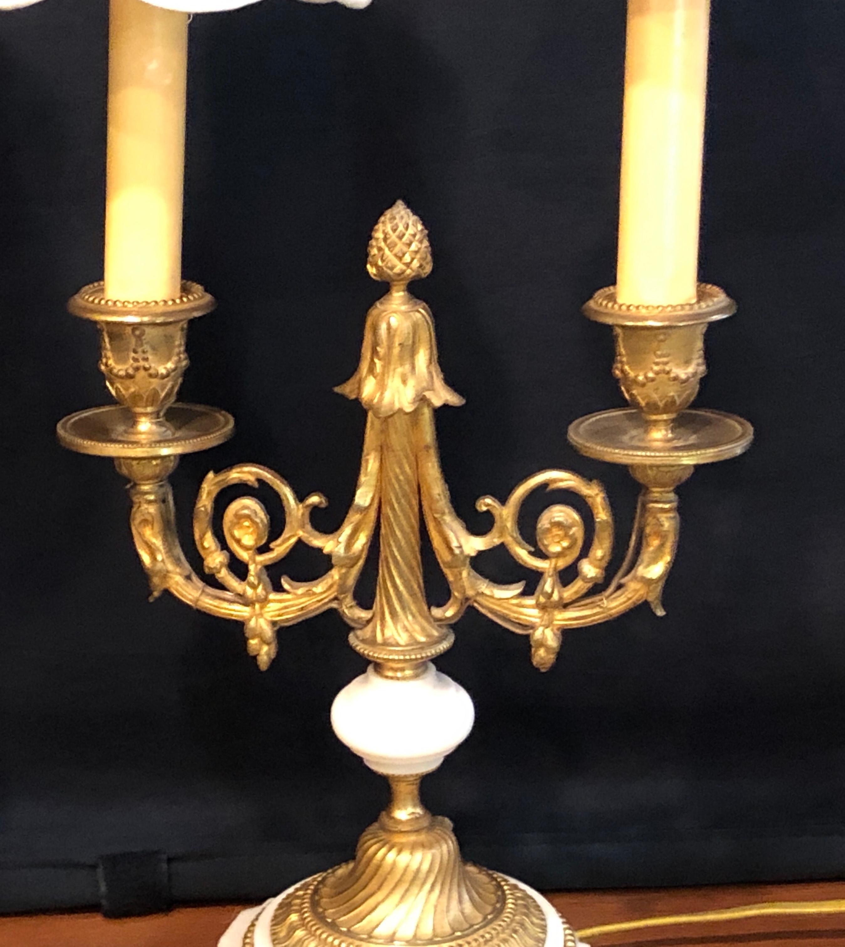 Pair of French Louis XVI style doré bronze and marble candelabra or table lamps. These fine 19th- early 20th century table lamps are simply stunning with the finest doré bronze castings one could hope for. Sitting on bronze feet and marble bases and