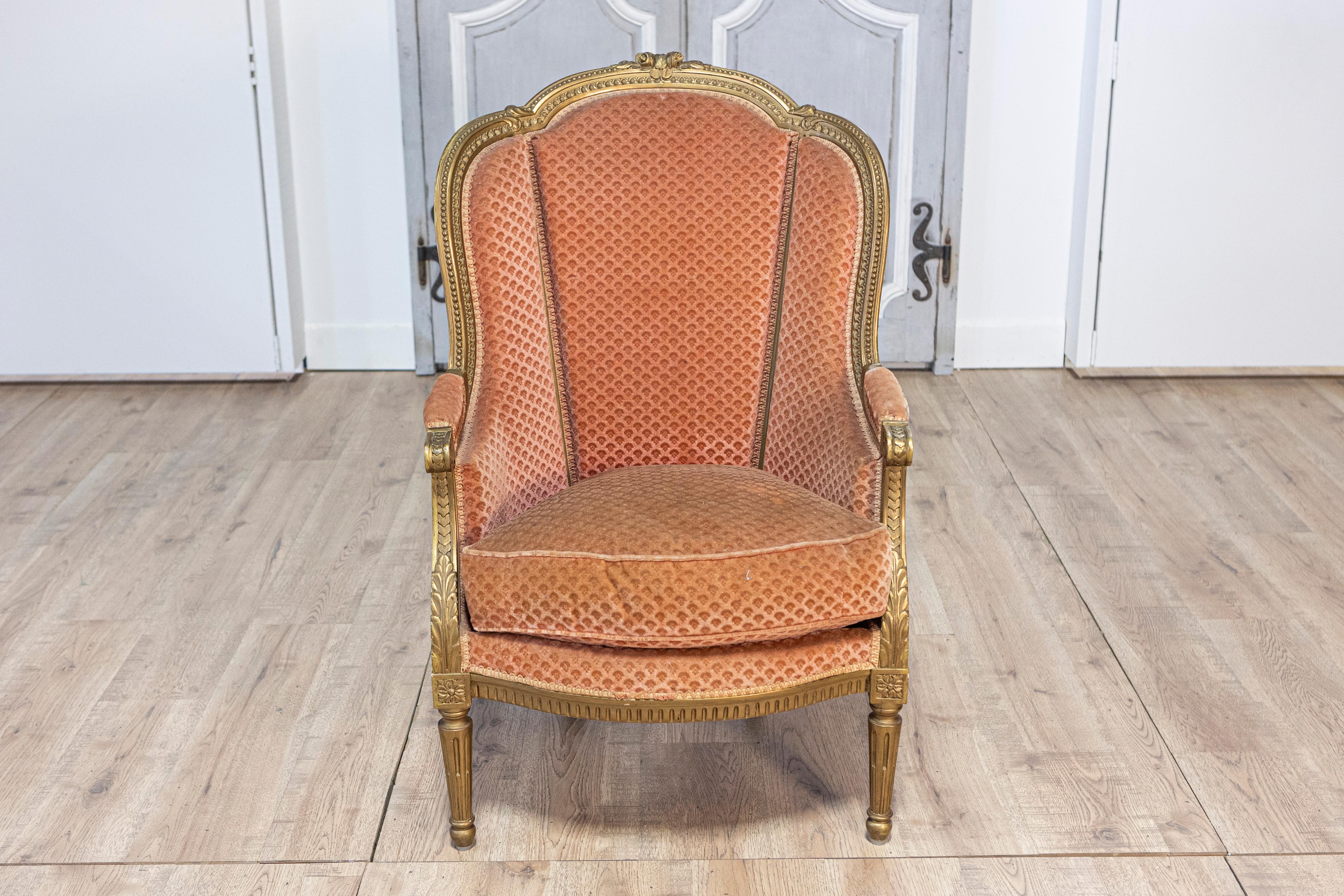20th Century Pair of French Louis XVI Style Gilded Wood Bergères Chairs with Carved Décor For Sale