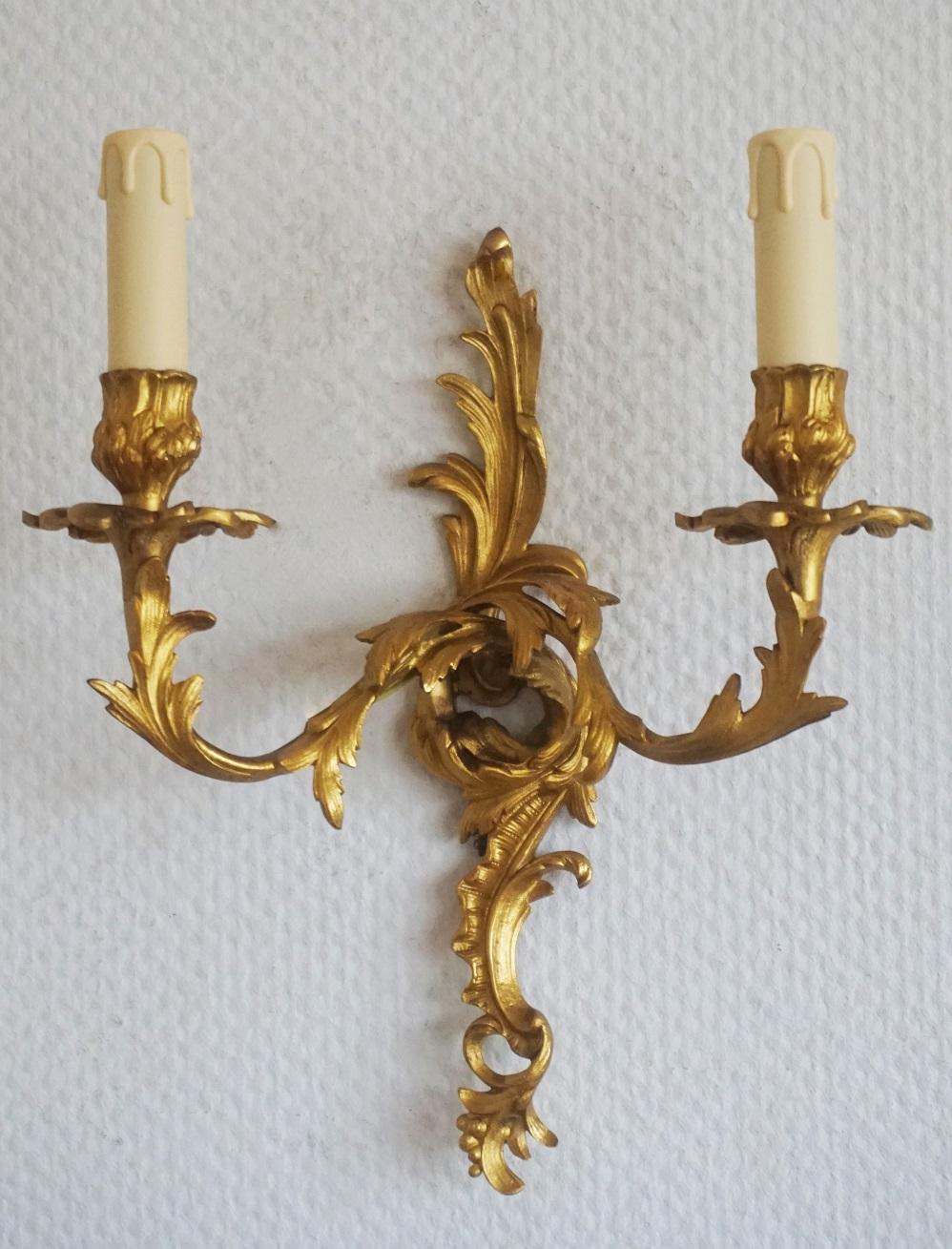 A pair of Louis XVI style gilt bronze two-light sconces richly decorated with foliage, France, circa 1880-1890. Shades not included.
Two E14 candelabras light bulb holders with candle covers (each sconce).
Measures:
Height 14