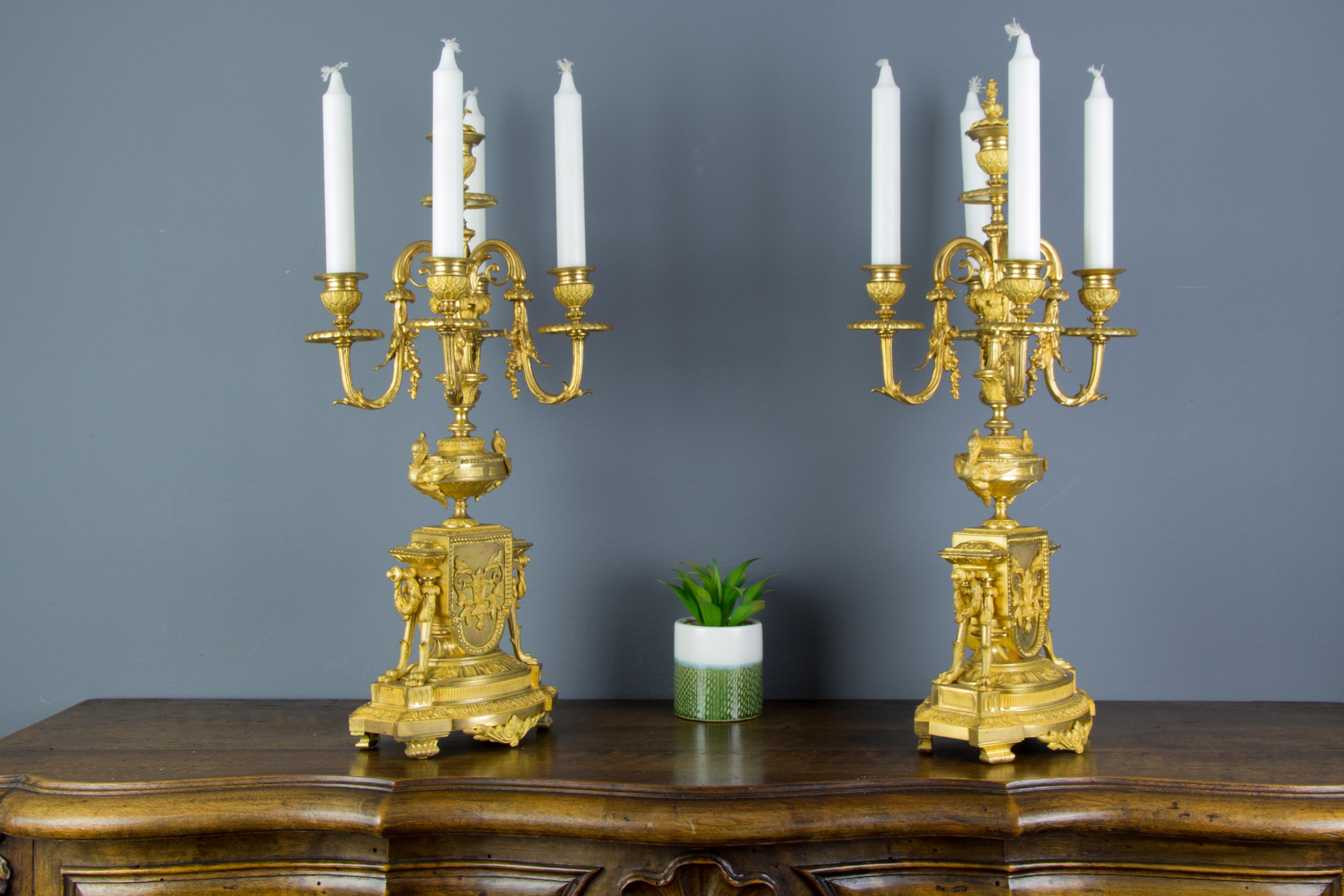 A pair of stunning and very fine quality French late 19th century Louis XVI style gilt bronze five-light candelabras.
Candelabras are decorated with swans, garland swags, and two paw feet on each side. These antique candleholders have removable
