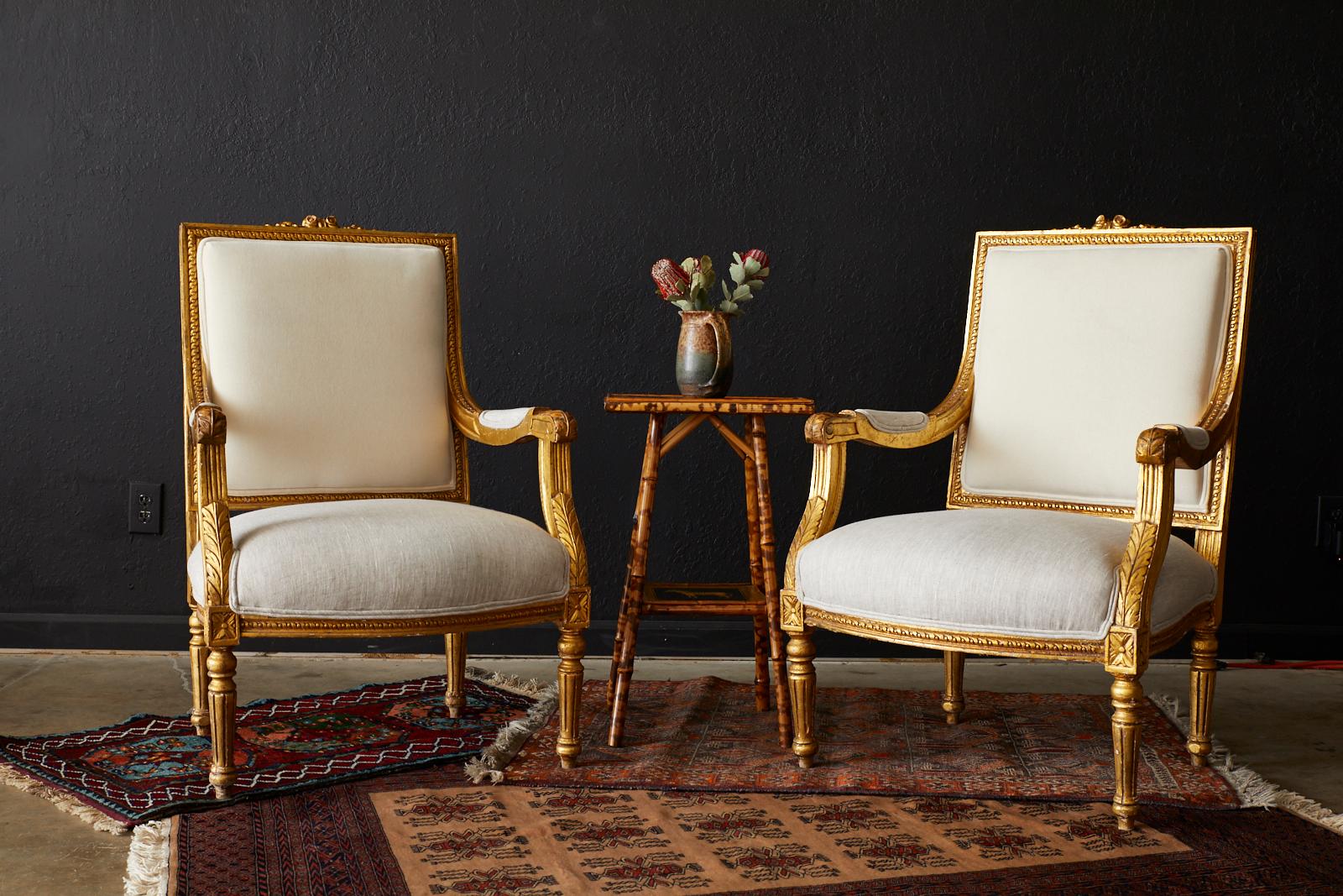 Fabulous pair of French giltwood fauteuils a La Reine by Rachel Ashwell's shabby chic couture. Made in the Louis XVI taste late 19th century and reimagined by Ashwell circa 1980s. Featuring a generous large frame highly carved and embellished with