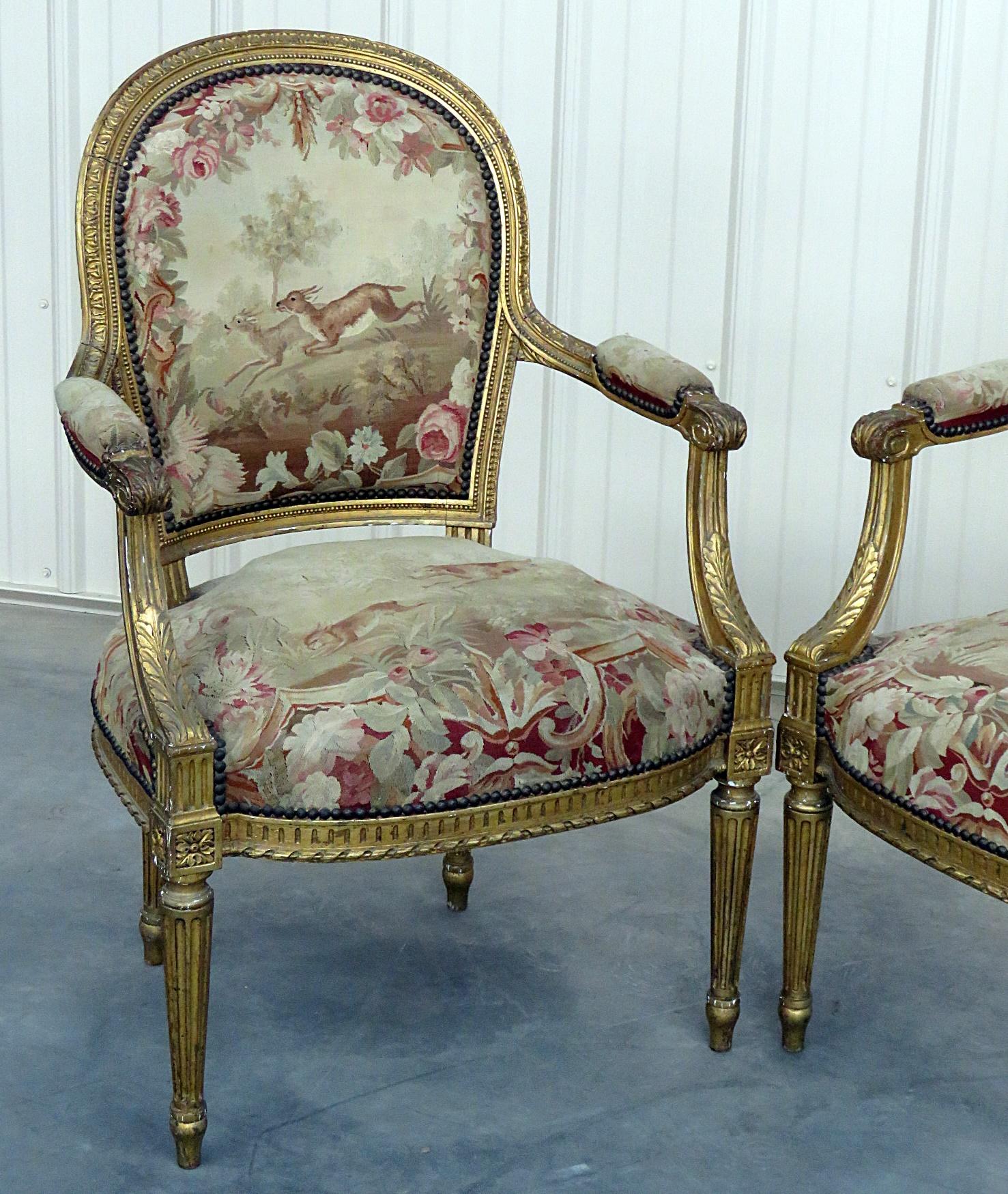 Pair of French Louis XVI style needlepoint fauteuils with gilt frames.