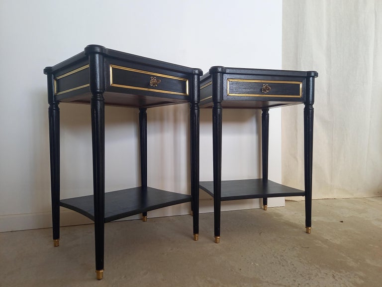 Antique French Louis XVI Style pair of nightstands, fluted legs finished with golden bronze clogs. 
A dovetailed small drawers with brass details and keys.