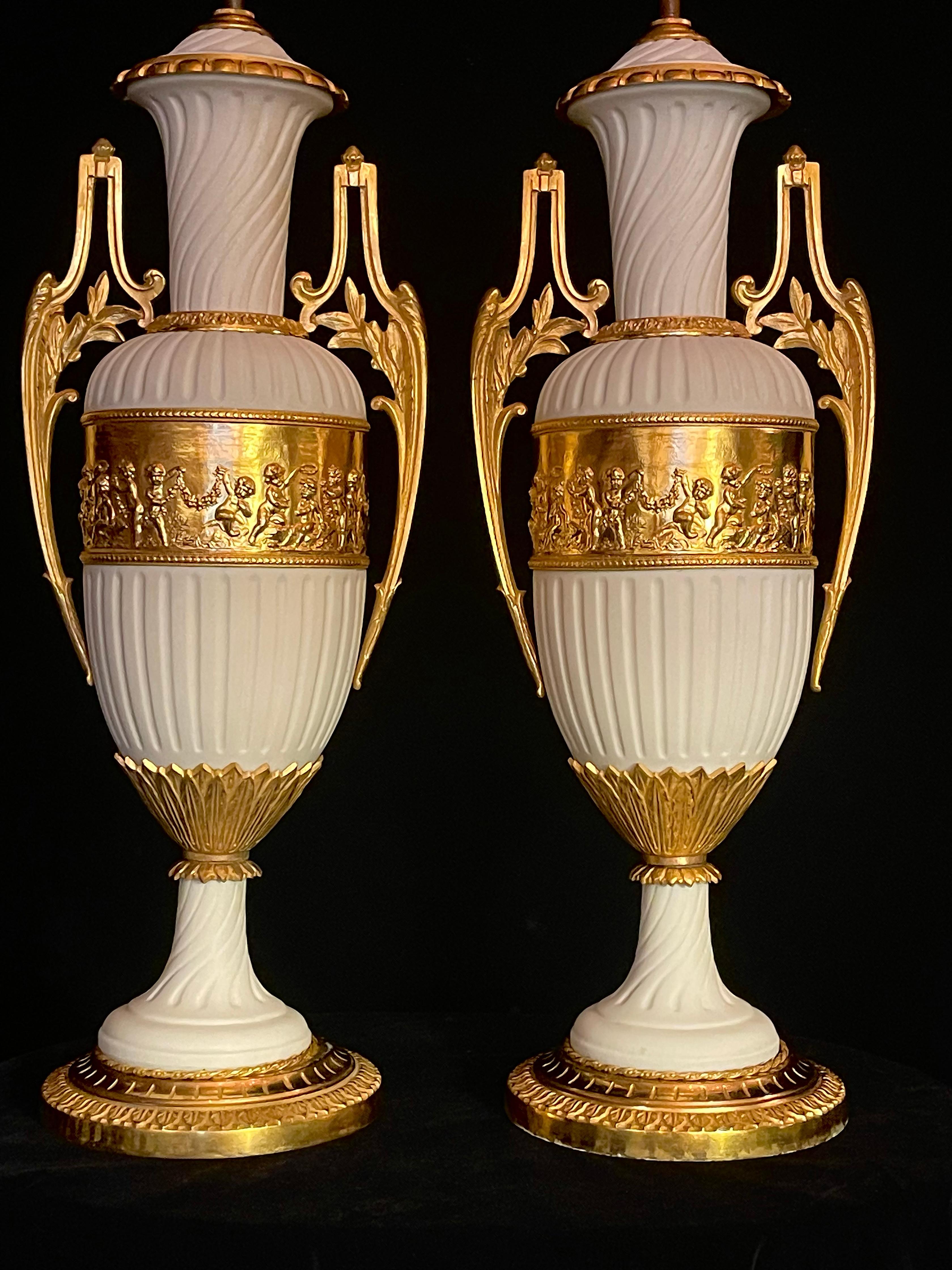 An elegant and refined pair of French Louis XVI style ormolu-mounted biscuit porcelain lamps. This exquisite pair of French lamps is crafted in the Louis XVI style, showcasing the harmonious pairing of unglazed white biscuit porcelain and finely
