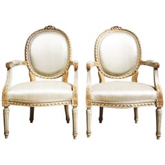 Pair of French Louis XVI Style Painted and Parcel Gilded Fauteuils