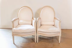 Pair of French Louis XVI Style Painted Bergères Chairs with Oval Shaped Backs