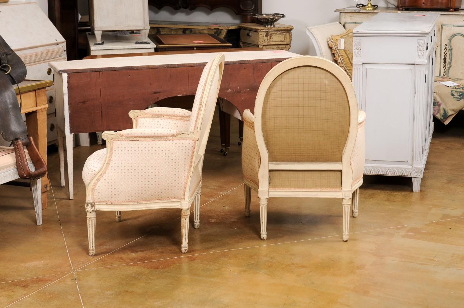 Pair of French Louis XVI Style Painted Bergères Chairs with Oval Shaped Backs For Sale 1