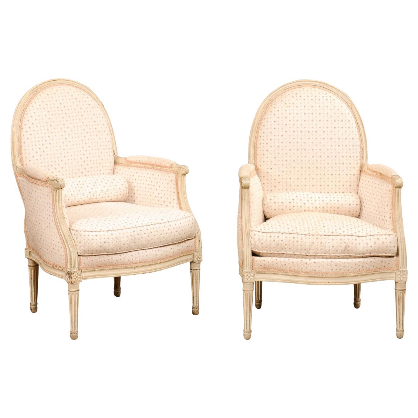 Pair of French Louis XVI Style Painted Bergères Chairs with Oval Shaped Backs