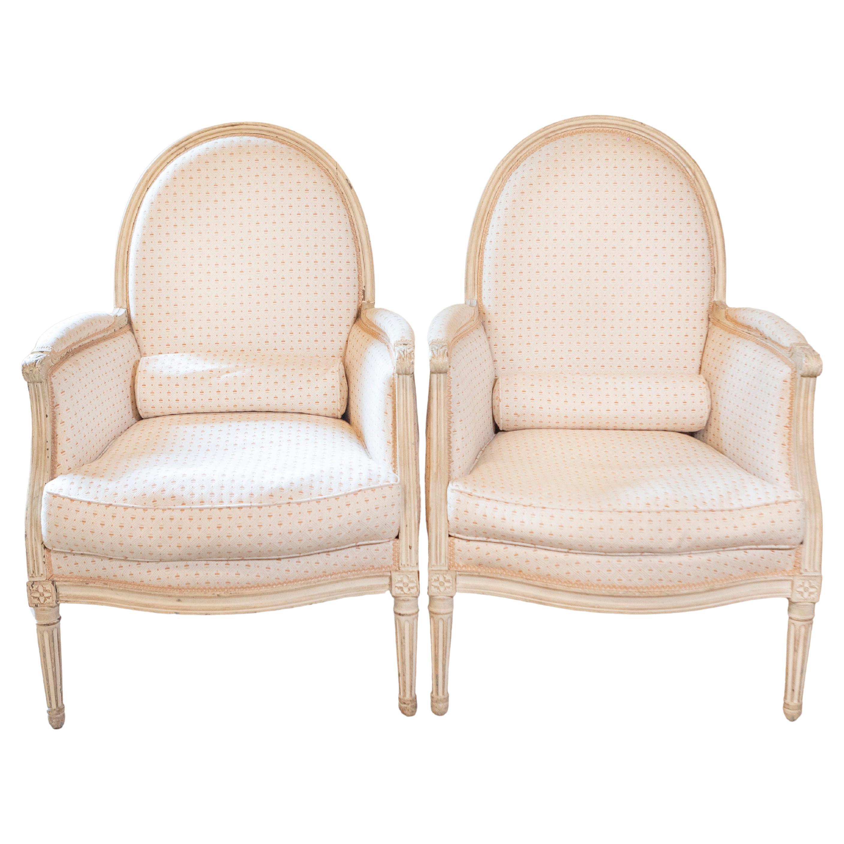 Pair of French Louis XVI Style Painted Bergères Chairs with Oval Shaped Backs For Sale