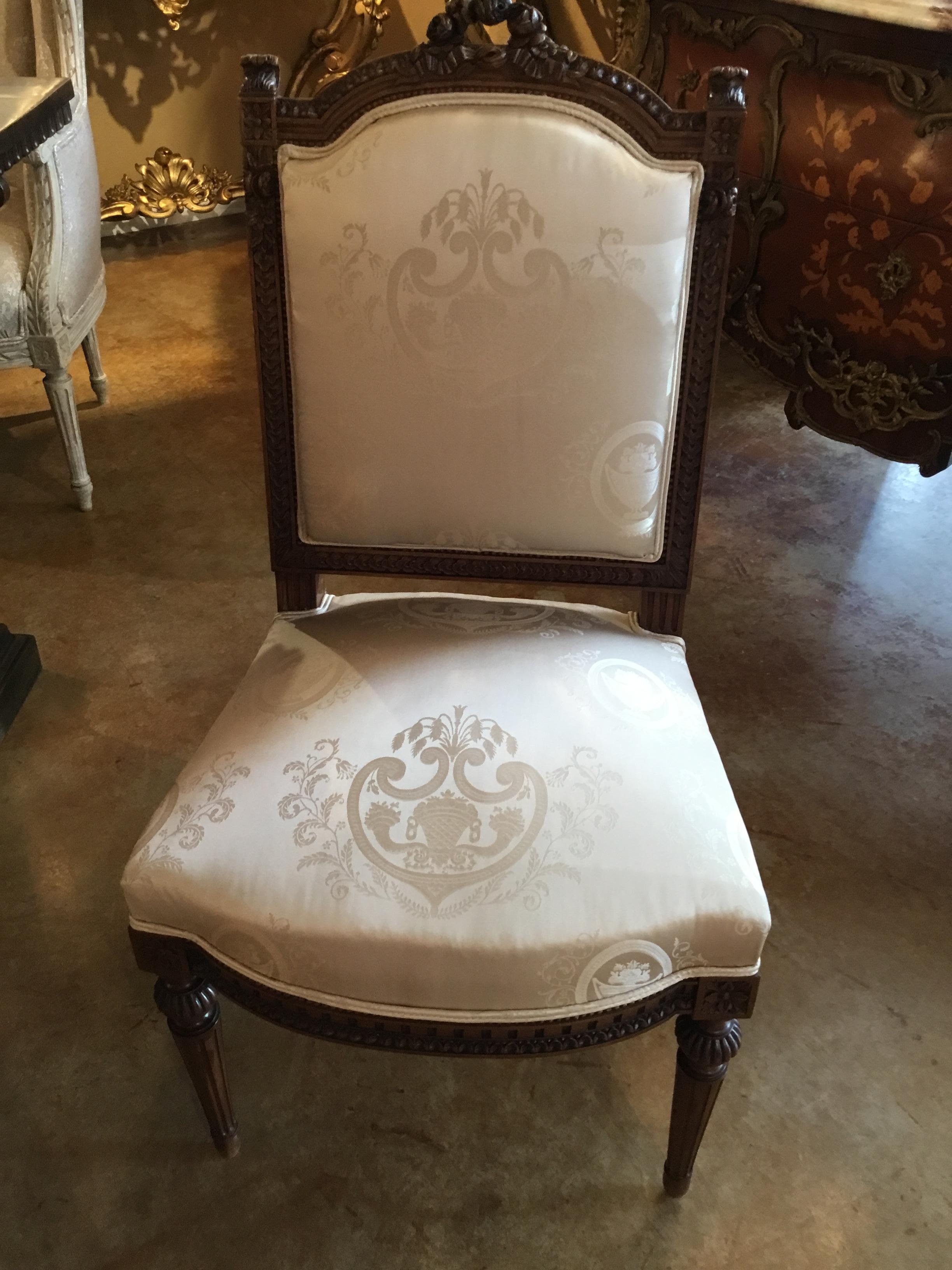 Pair of lovely side chairs without arms. White silk new upholstery
Reeded legs and a carved crest of roses.