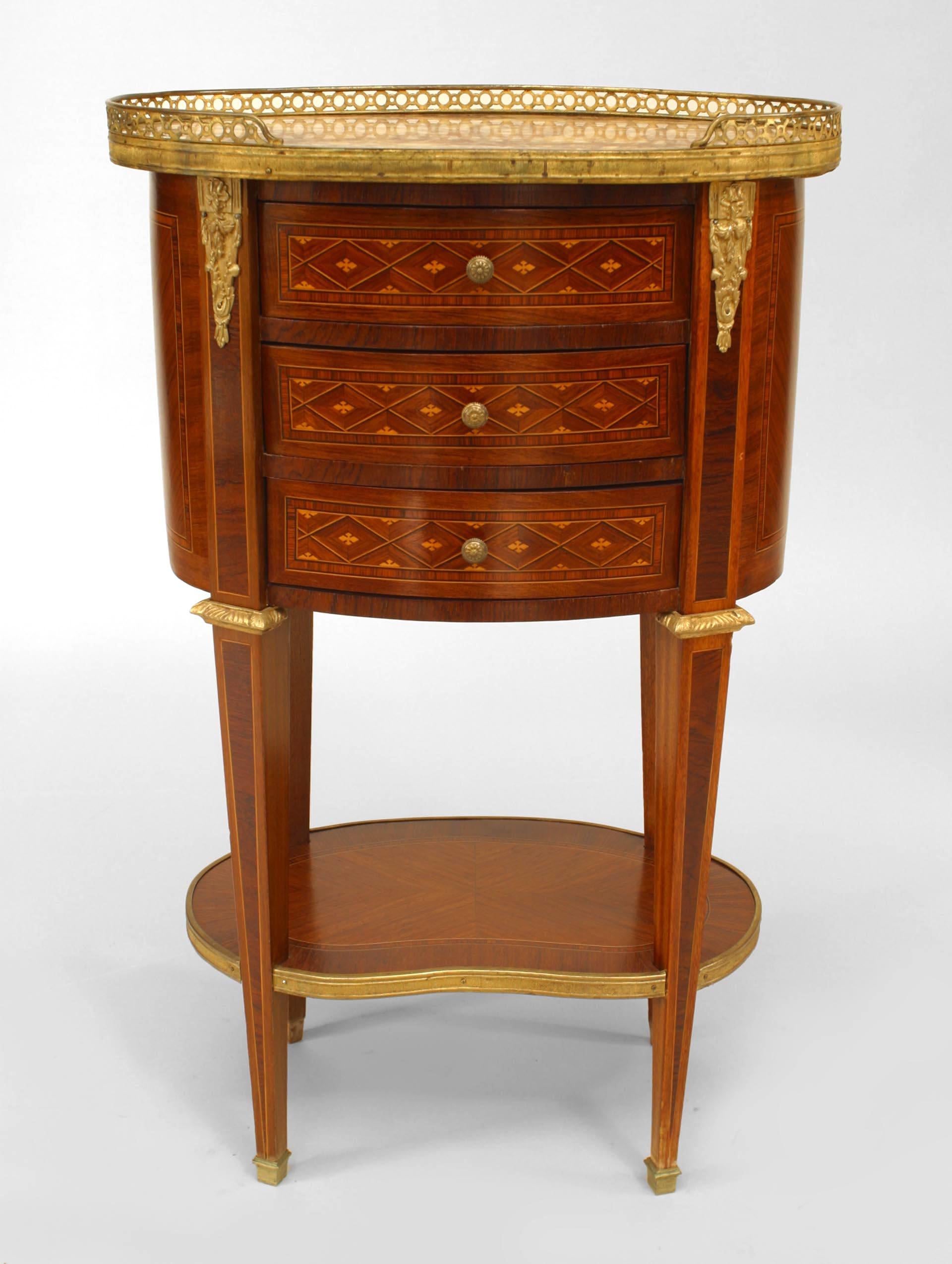 Pair of French Louis XVI-style (19th Century) oval form small bedside commodes (chevets) with parquetry inlaid design, three drawers, a bottom shelf, bronze trim and gallery, and marble top with gallery (PRICED AS Pair)
