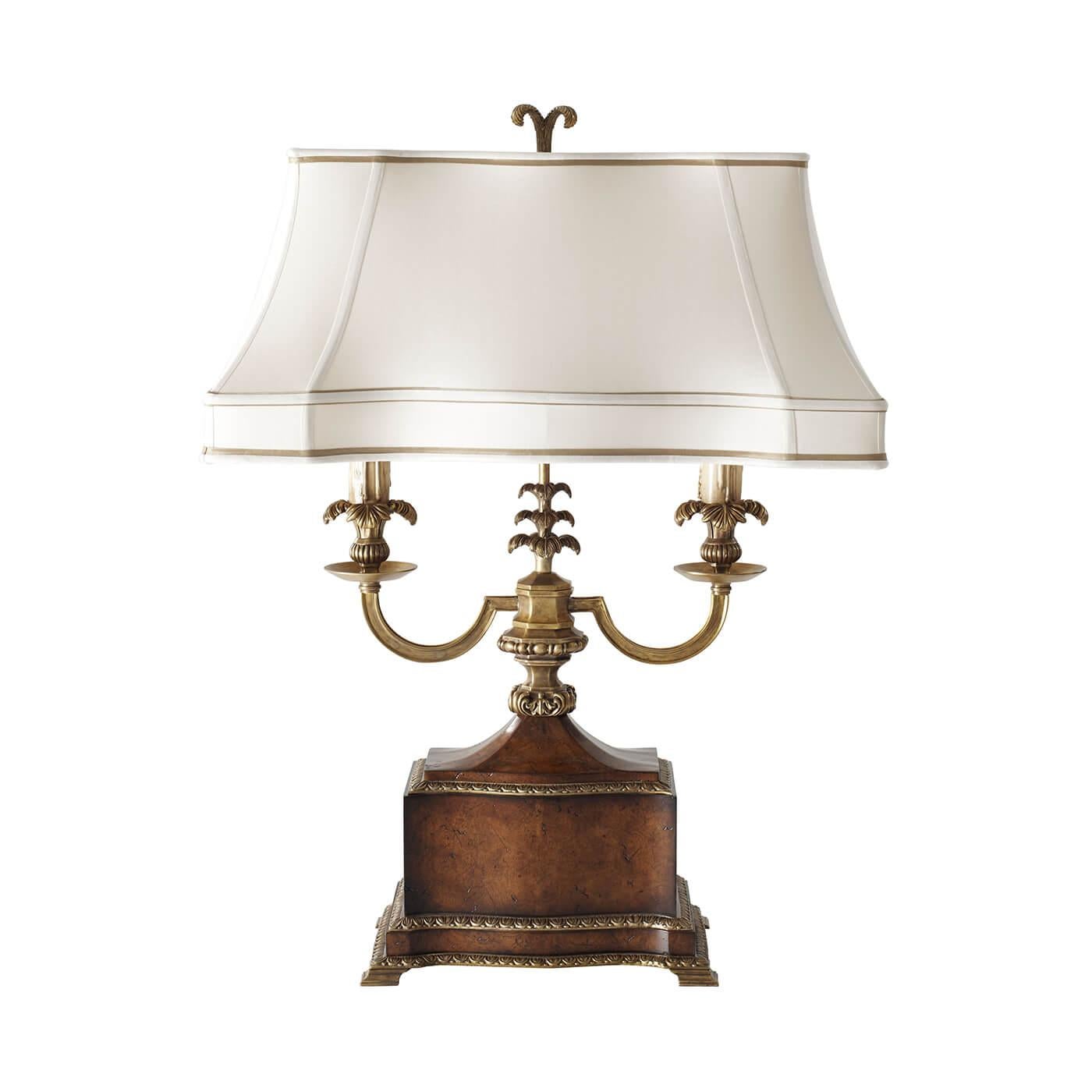 A French Louis XVI style pollard burl and finely cast brass table lamp, the twin light arms above a shaped base with brass mounts surmounted by hand-sewn silk shade. 

Dimensions: 22
