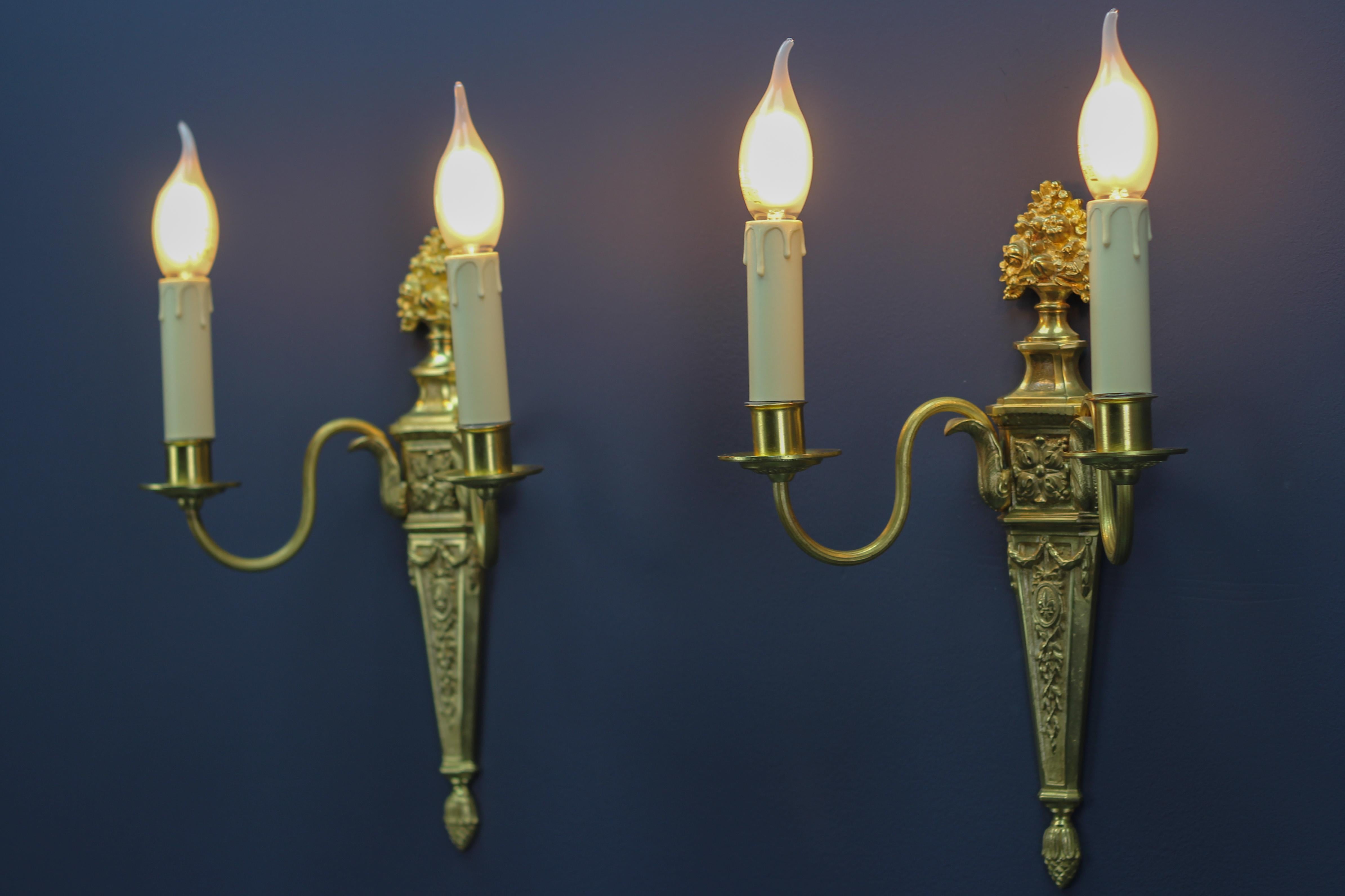 Early 20th Century Pair of French Louis XVI Style Two-Light Gilt Bronze and Brass Sconces For Sale