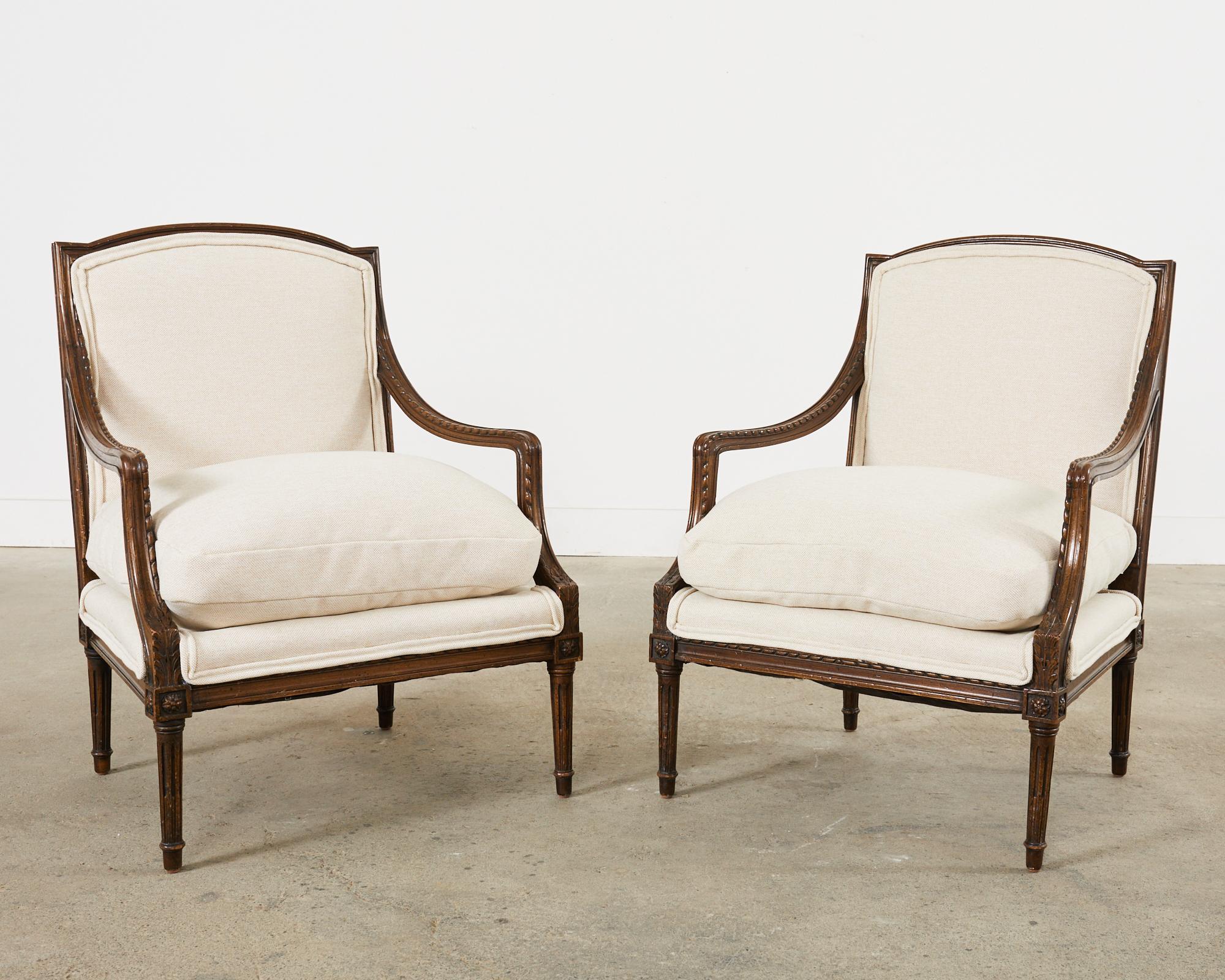 Fabric Pair of French Louis XVI Style Walnut Armchairs For Sale