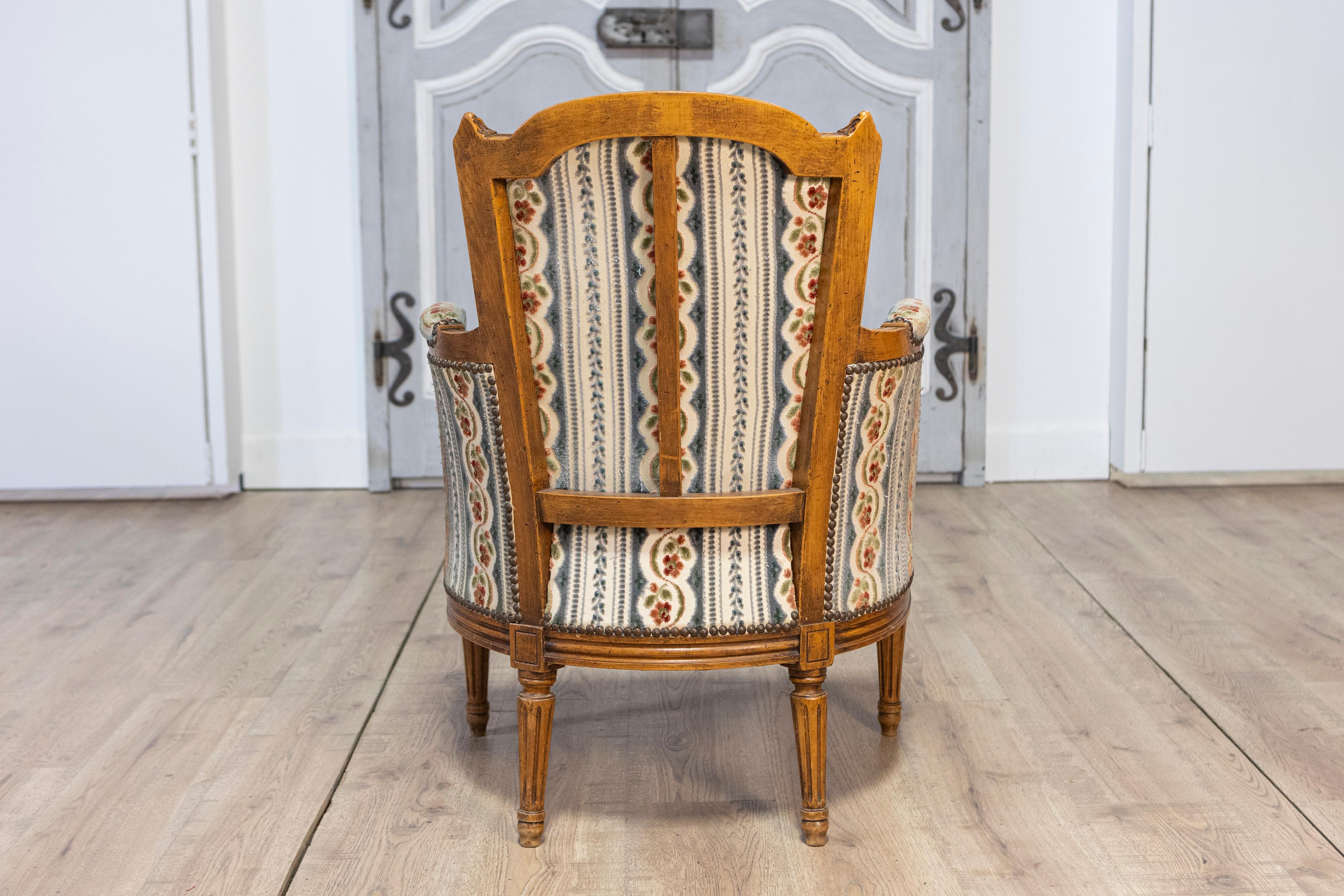 Pair of French Louis XVI Style Walnut Bergères Chairs with Carved Fluted Legs For Sale 7