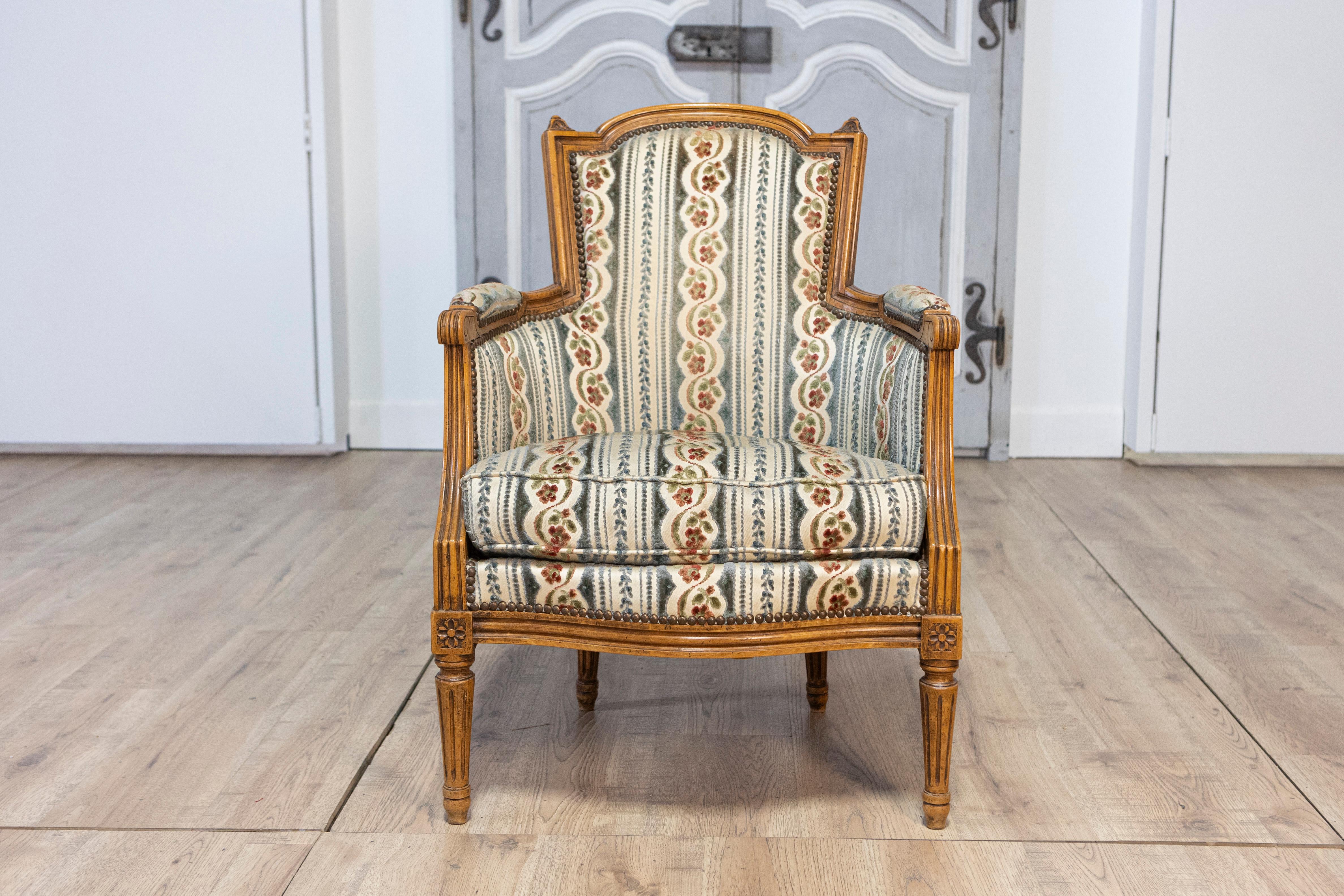 Upholstery Pair of French Louis XVI Style Walnut Bergères Chairs with Carved Fluted Legs For Sale