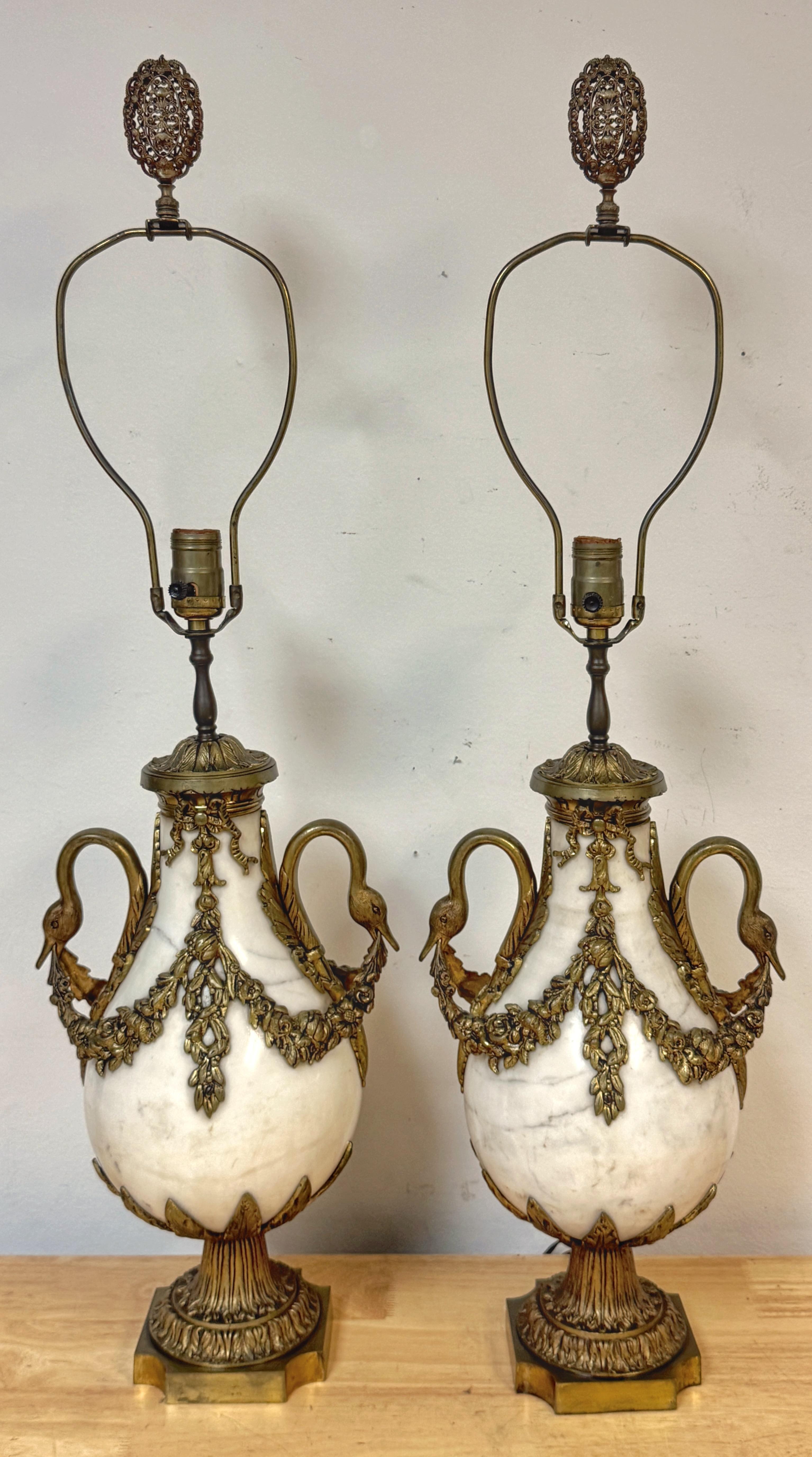 Pair of French Louis XVI Style White Marble & Gilt Bronze Swan-Handle Urn Lamps

A grand pair of French Louis XVI style urns, dating to the late 19th century and later mounted as lamps in the early 20th century, crafted of white marble with richly