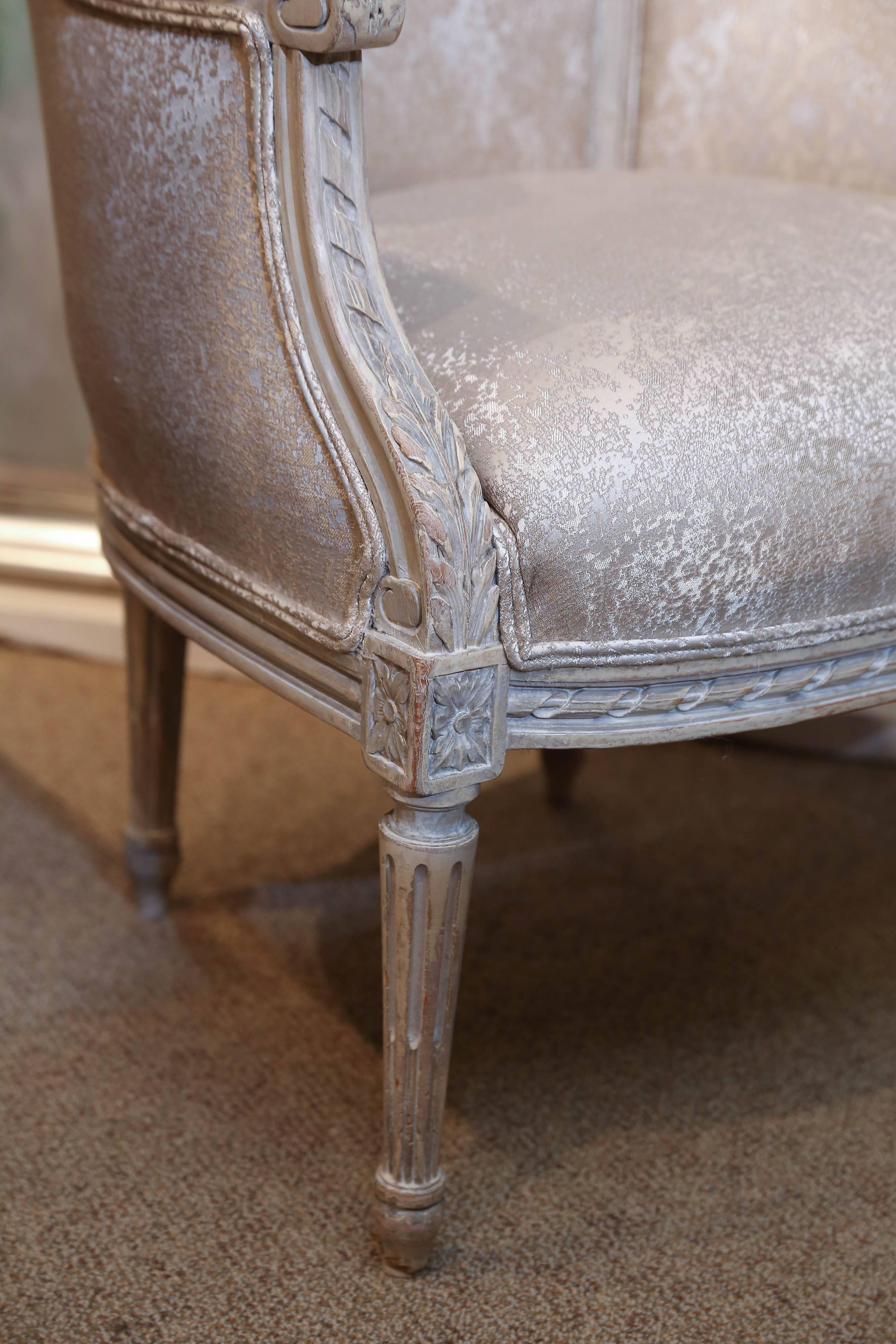 Newly upholstered pair of painted Louis XVI style chairs.
Finely carved frame with a gadrooned scalloped edge.
Roses carved at the crest. Lovely reeded leg.