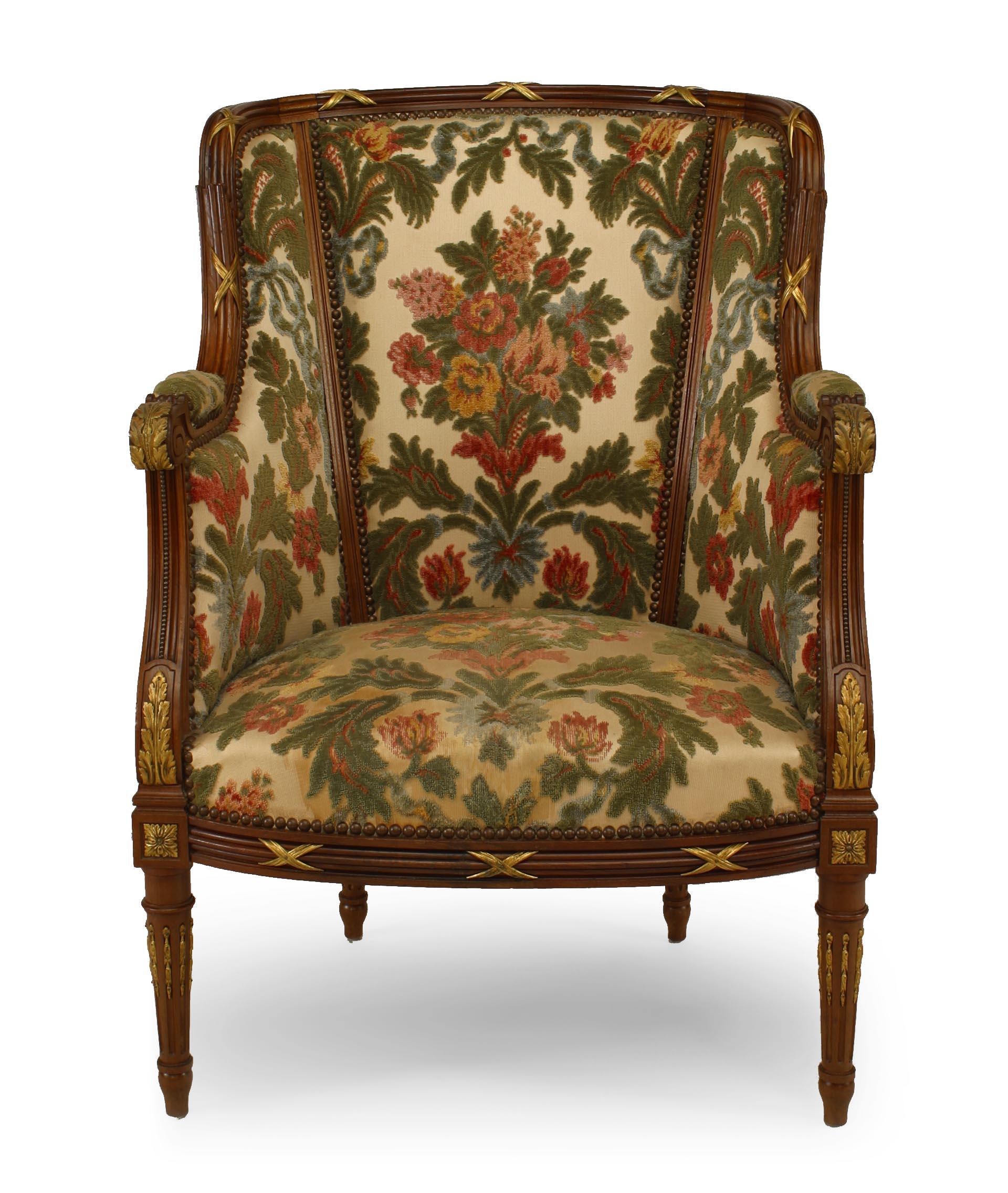 Pair of French Louis XVI style (20th century) bergeres with floral cut velvet tapestry upholstery with matching ottoman (3 piece set).