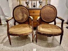 Pair of French Louis XVI Walnut Armchairs or Fauteuils, Hand Carved